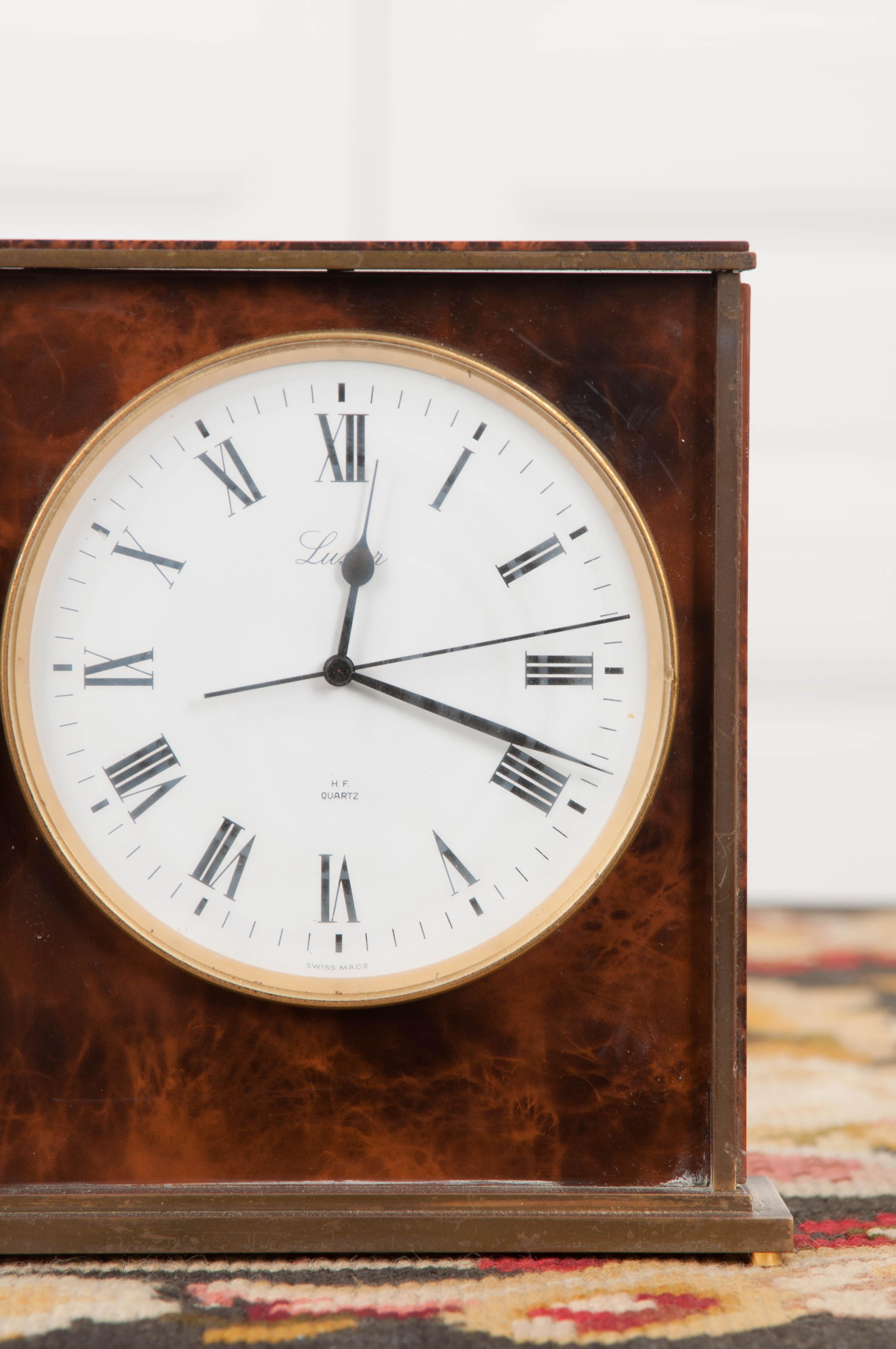 This handsome vintage faux tortoiseshell and brass desk clock, circa 1930s, is from Switzerland and features a quartz movement. The 4