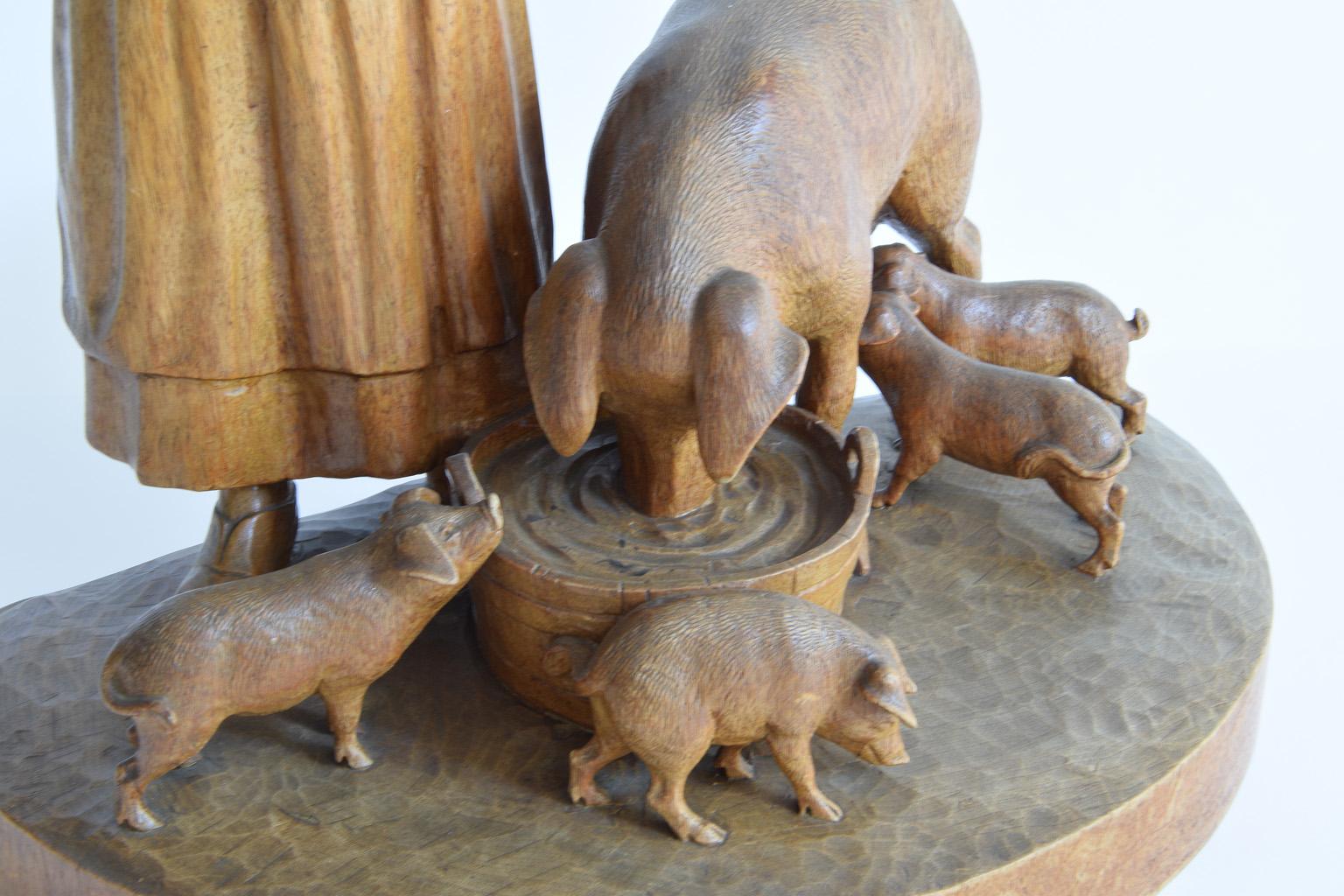 Feeding of cute pigs family with maiden - Swiss wood carving from Hans Trauffer (1899-1967) Davos in the 1930s. Brienz Wood Carving
Made from one piece of a block of wood. Very fine and detailed wood carving.
 