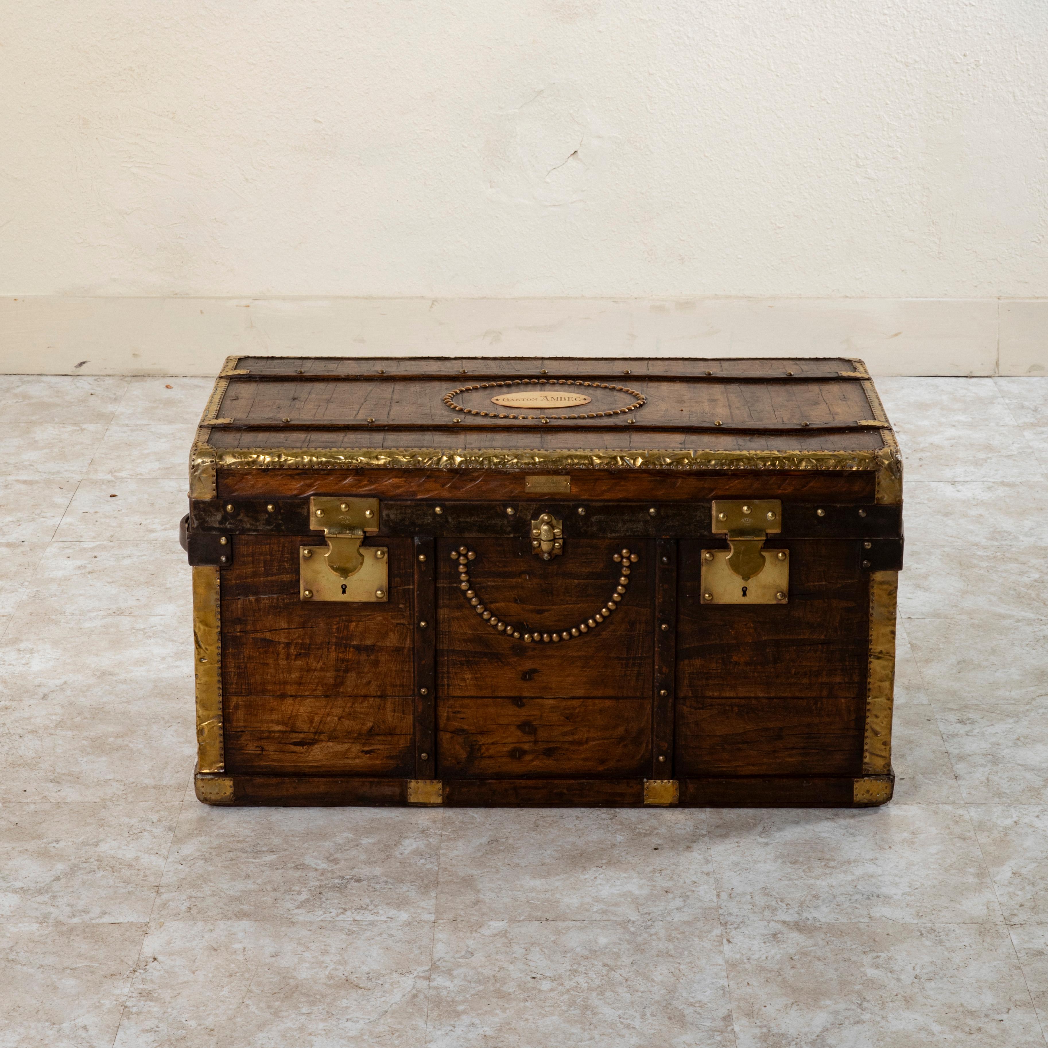 This wooden steam trunk from the late nineteenth century features locks stamped Depose, or trademarked, as well as a brass plaque marked Craeser, Malles & Maroquinerie, Laussanne (Suisse), the name of the manufacturer in Switzerland. The oval brass
