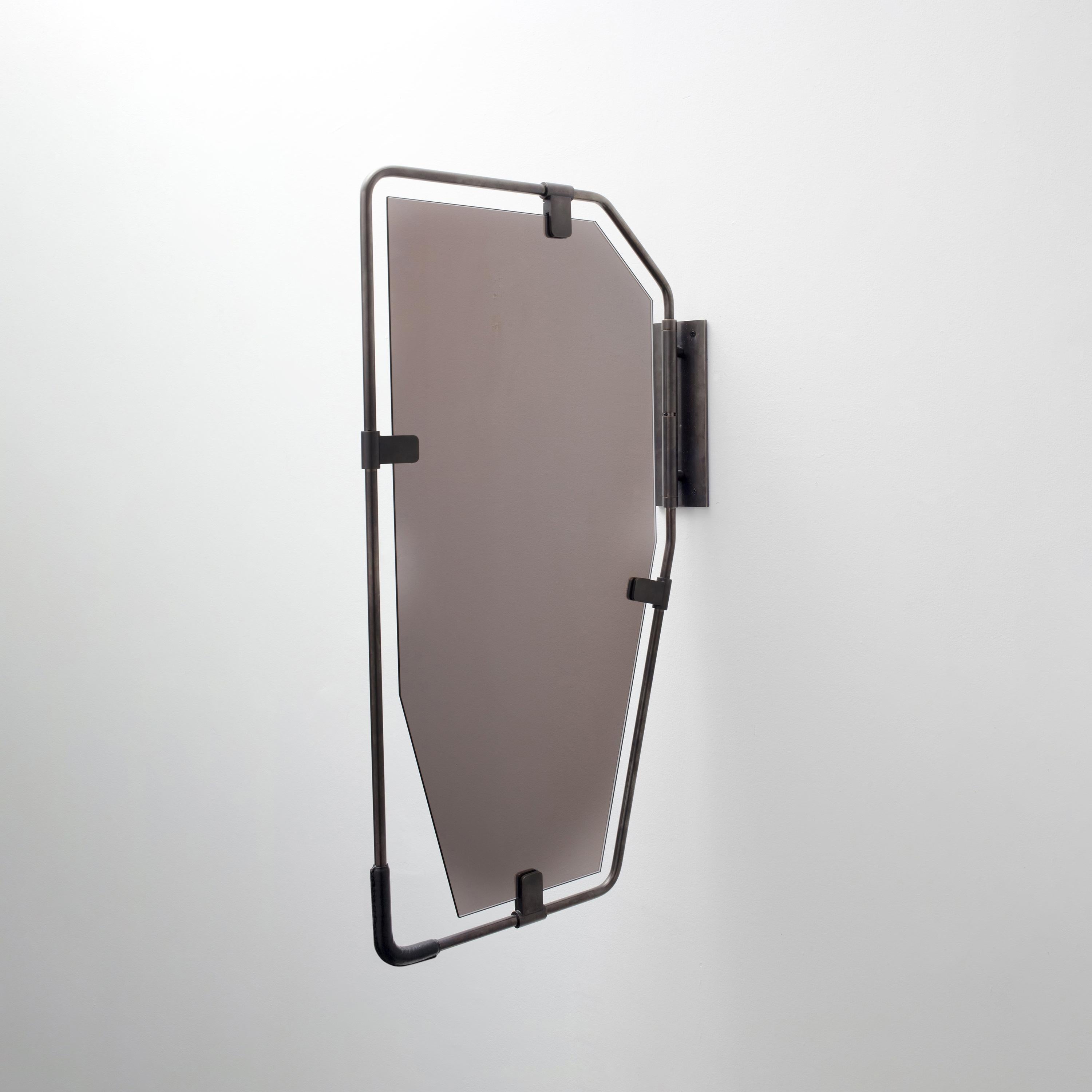 Showroom floor model. 

Handcrafted from brass tubing, the design of the Switch collection emphasizes the expression of material and the detailing of its components. The use of different finishes and patinas gives this unique mirror a retro