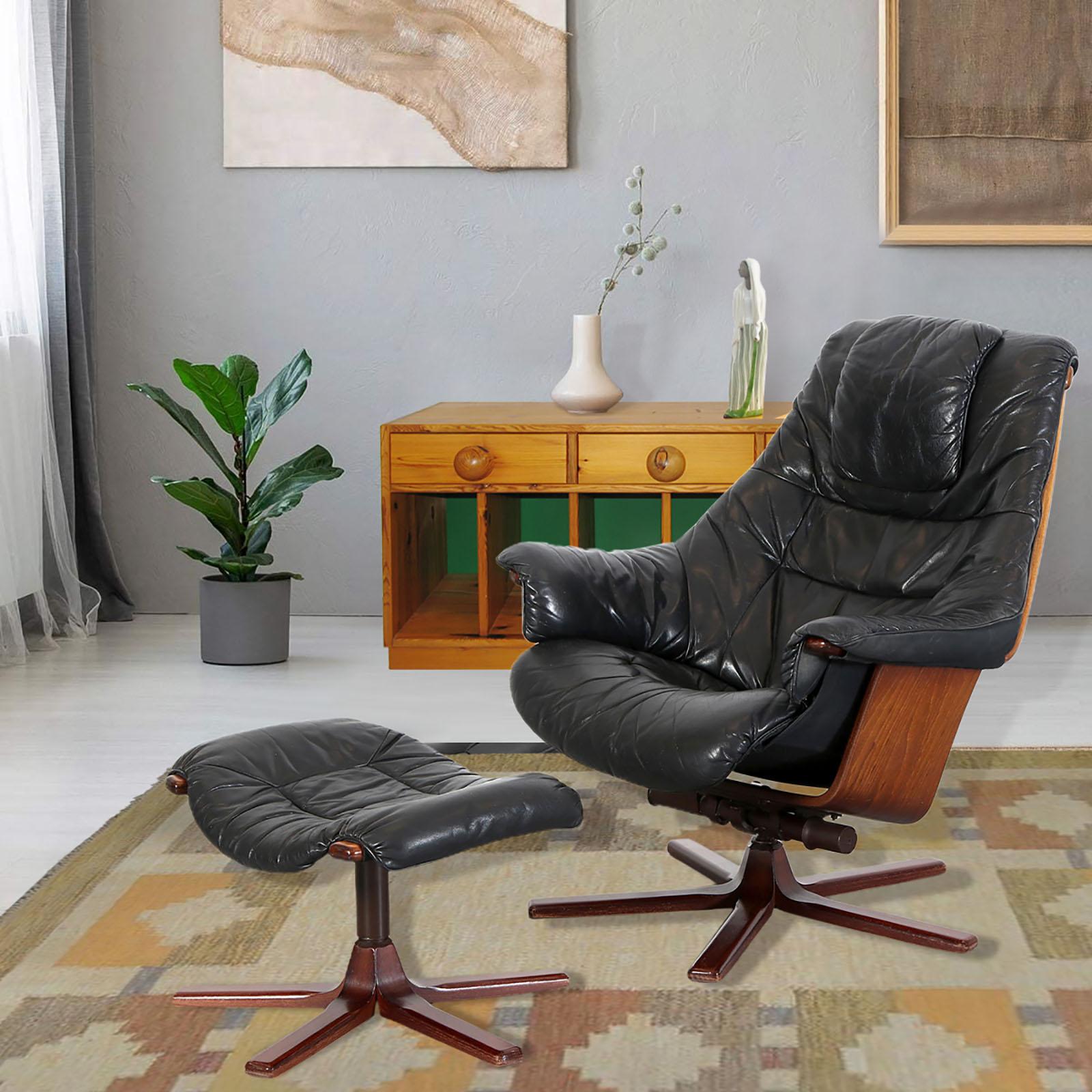 Swivel armchair with footrest, Göte Möbel, Sweden, 1970s
Made of stained beech with black leather upholstery. The seat is rotatable and in upward position adjustable. Original manufacturer label, marked under the bottom. Very good original