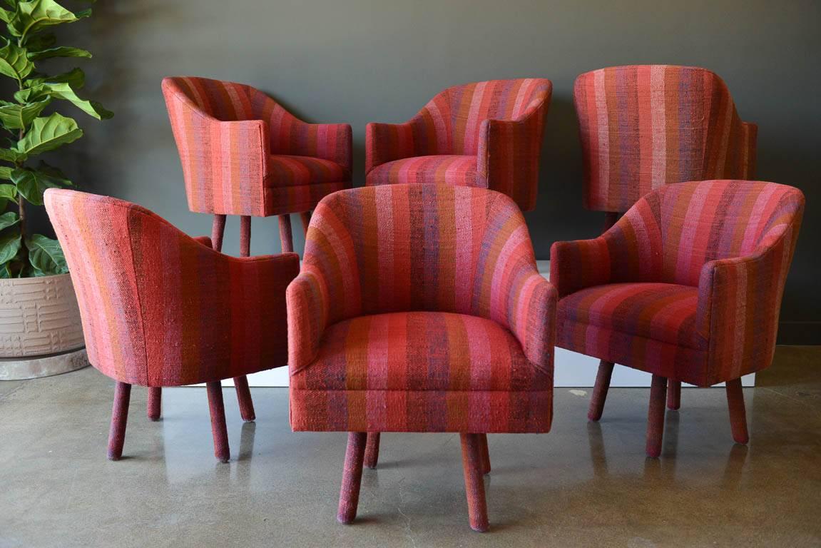Pair of swivel armchairs with vintage Jack Lenor Larsen Fabric, circa 1970. Beautiful vintage magenta wool stripe tweed with matching upholstered legs. Upholstery has been meticulously pattern matched and is in excellent vintage condition. No rips,