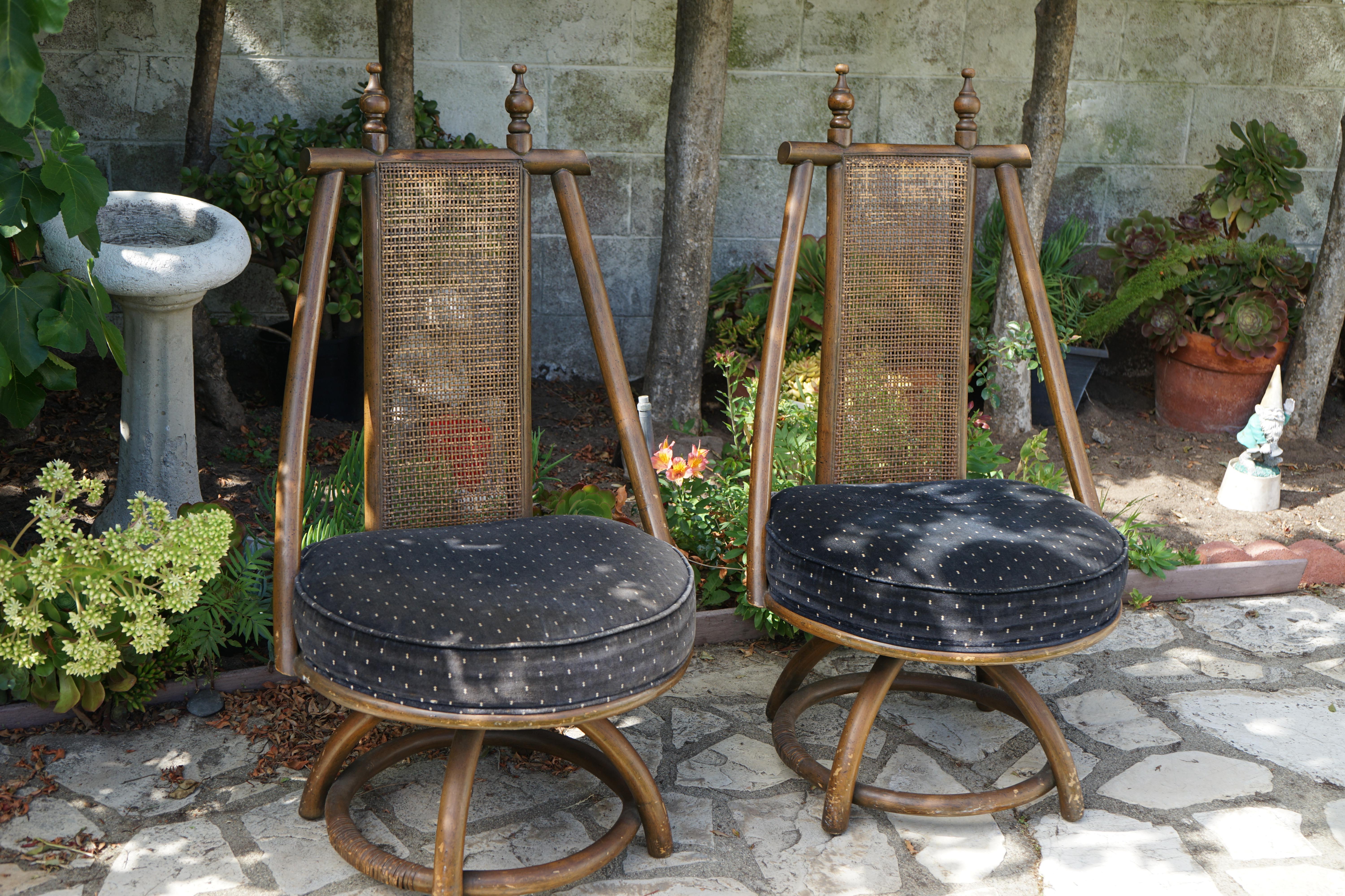 Rarity and vintage style meet in this pair of bentwod swivel chairs with cane and hand-carved finials. Everything is original on these Redondo Beach estate chairs that remained in their original home for more than 60 years. 
The armchairs are made