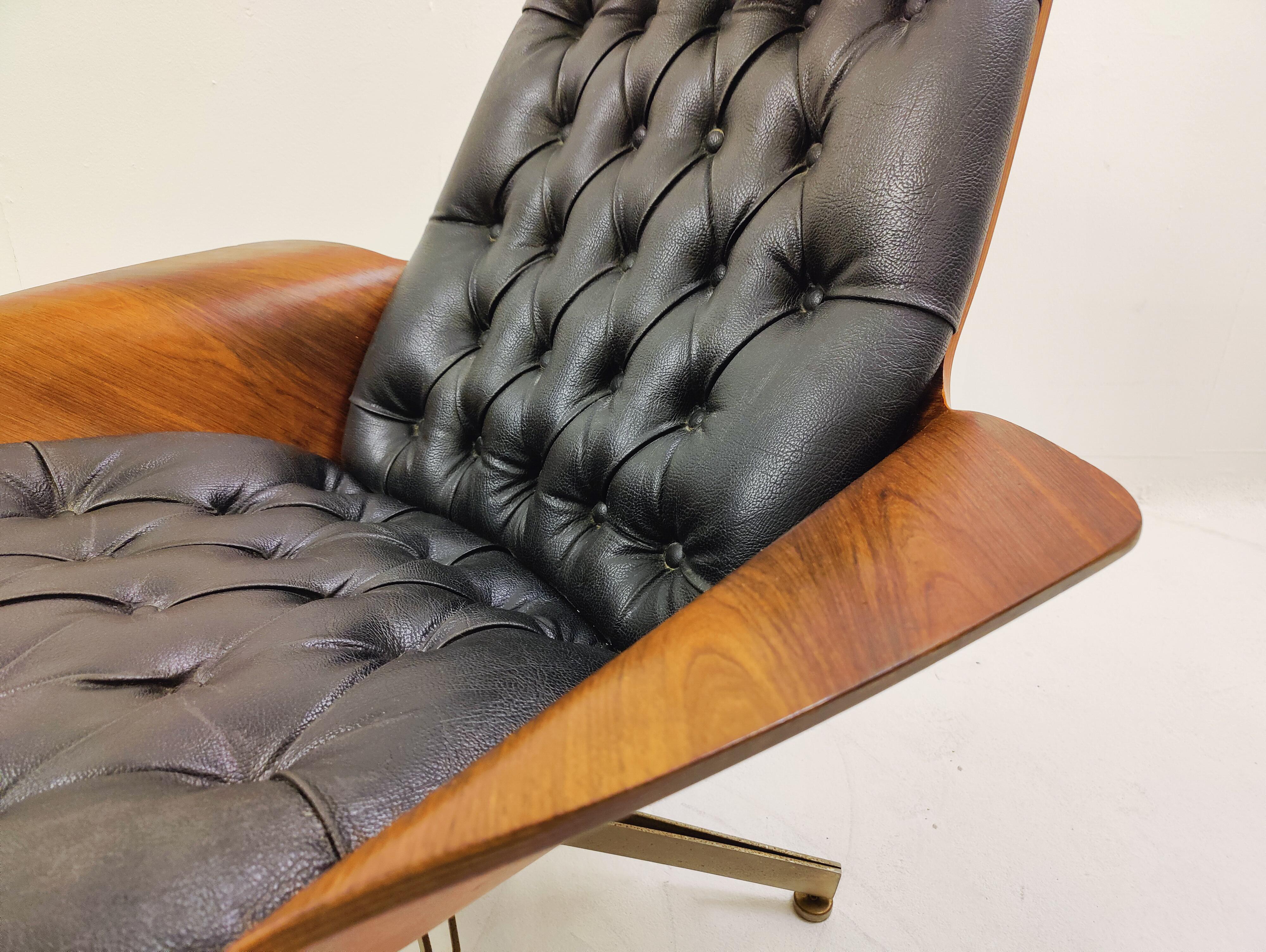 Mid-century Swivel black leather armchair with plywood Armrests and Ottoman by George Mulhauser - USA 1960s.