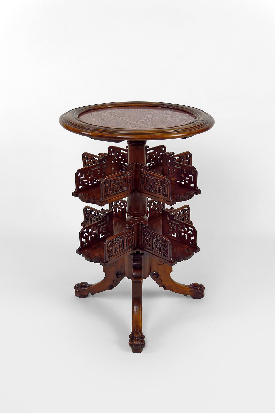 Rare pedestal table / revolving bookcase in Japanese / Chinese / Asian style, richly carved.

With red marble top with white veins, openwork swivel shelves and tripod base carved with dragon / demon heads and clawed legs.

Can be adapted to many