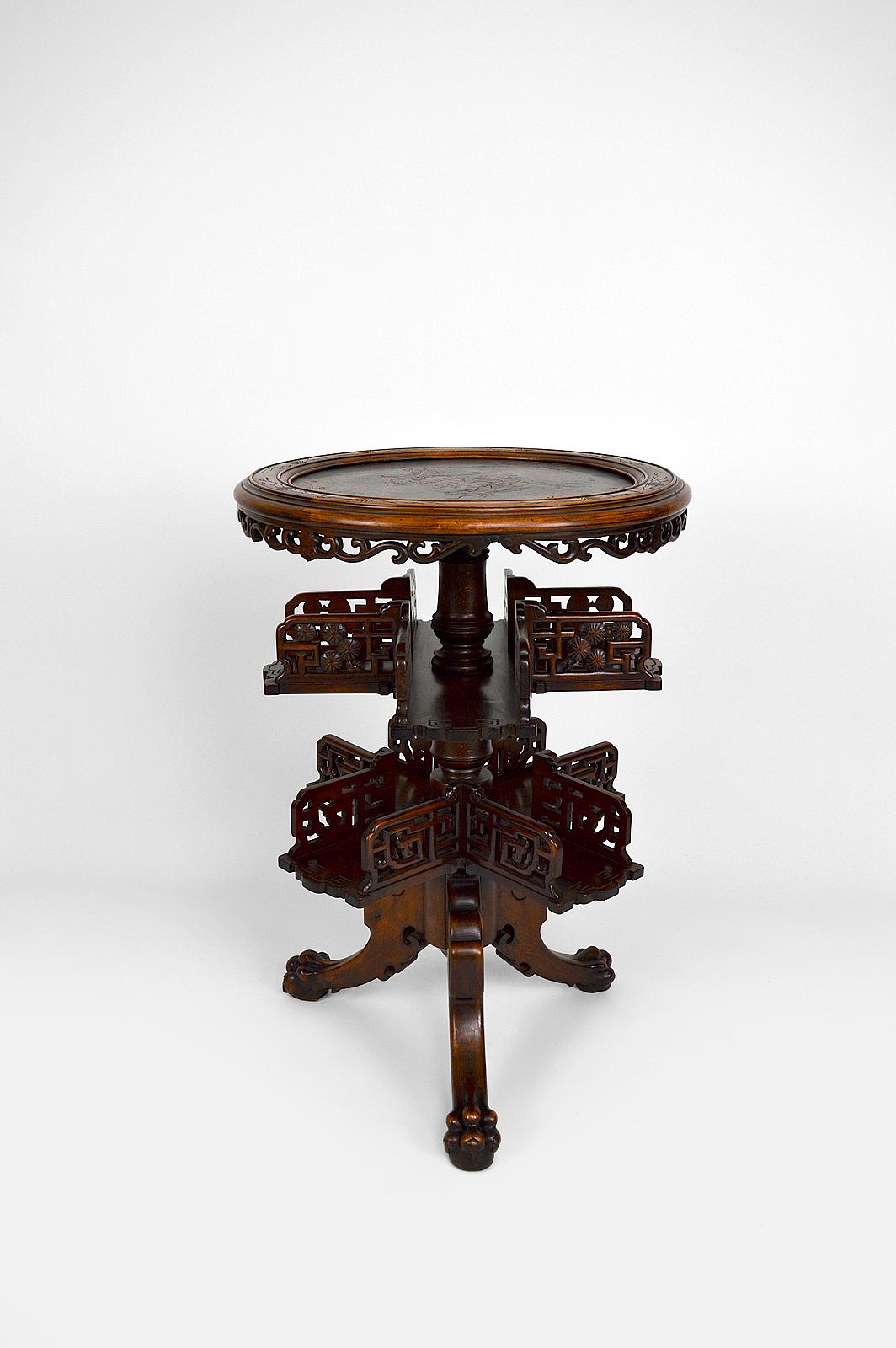 Rare pedestal table / bookcase in Japanese / Chinese / Asian style.

Richly carved : top decorated with a dragon, openwork swivel shelves and tripod base carved with clawed legs.

Art Nouveau / Japonisme, France, around 1880.
By Gabriel Viardot