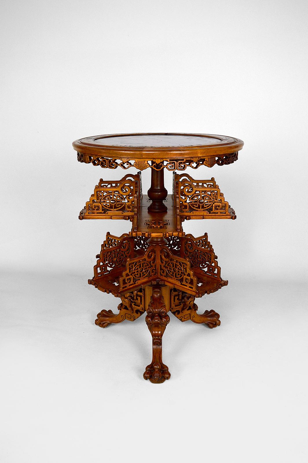 Rare pedestal table / bookcase in Japanese / Chinese / Asian style, richly carved.

With red marble top, swivel shelves and tripod base carved with dragon / demon heads and clawed legs.

Art Nouveau / Japonisme, France, around 1880.
By Gabriel