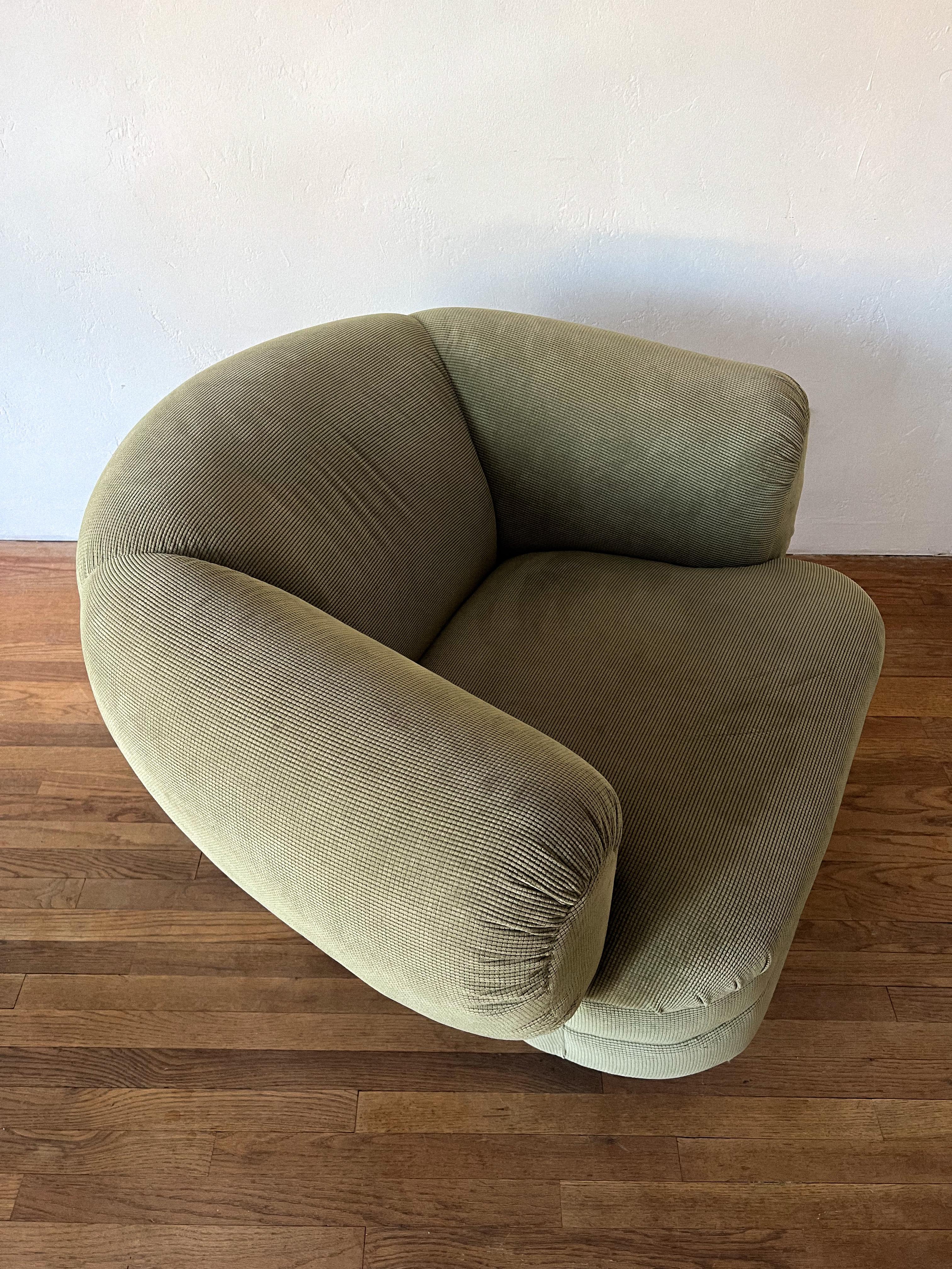 Postmodern swivel and tilt accent chair by Vladimir Kagan for Directional. Curved and oversized with padded arm rests and a wide seat, this chair was made for lounging. Covered in super soft textured velvet in sage green. Unmarked.