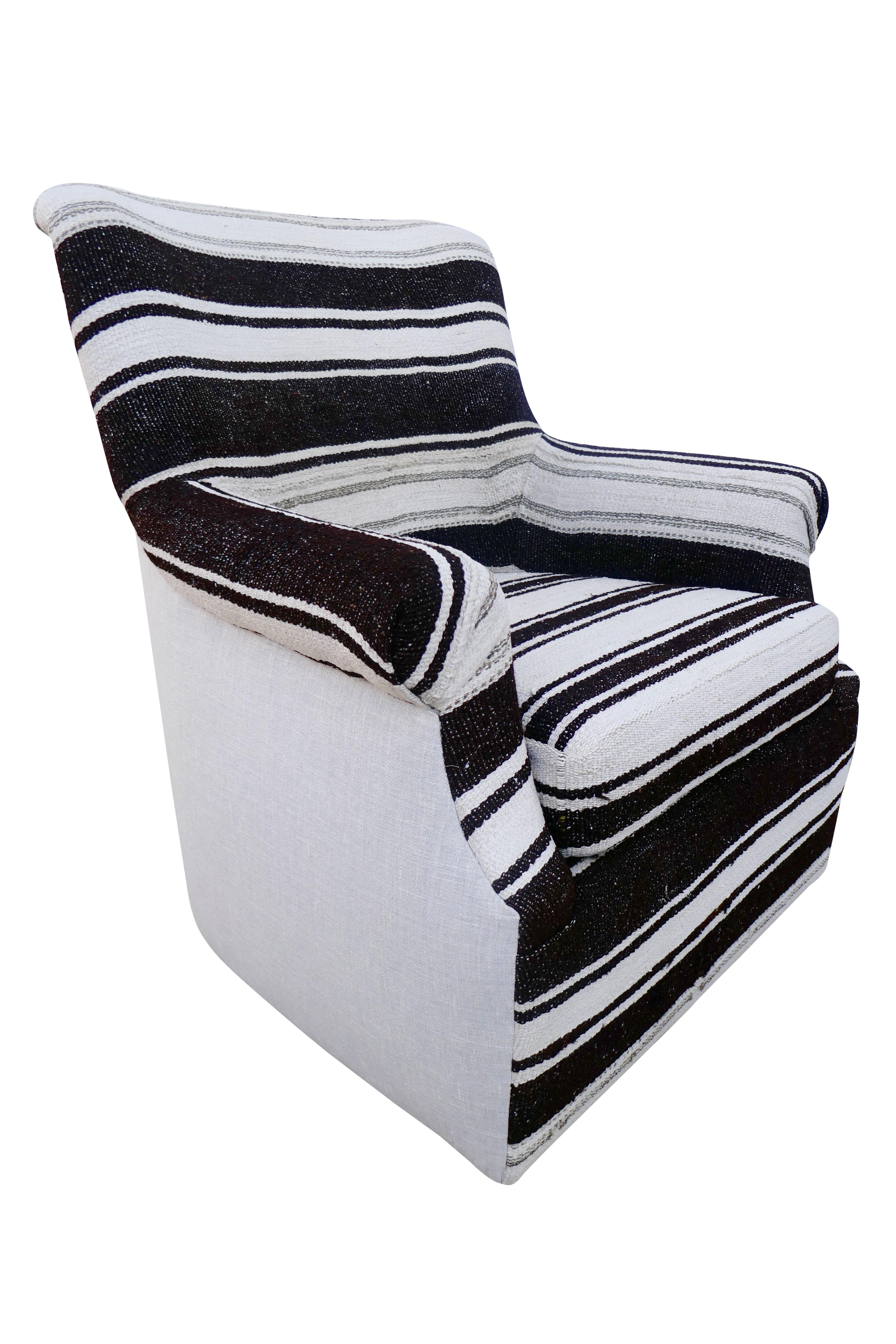 One-of-a-kind swivel club chair in vintage Berber tribal striped Kilim wool. Impeccably upholstered in authentic vintage (circa 1960's) Berber handwoven textile. Heavy texture created from organic hemp, wool and goat-hair in natural & espresso tones