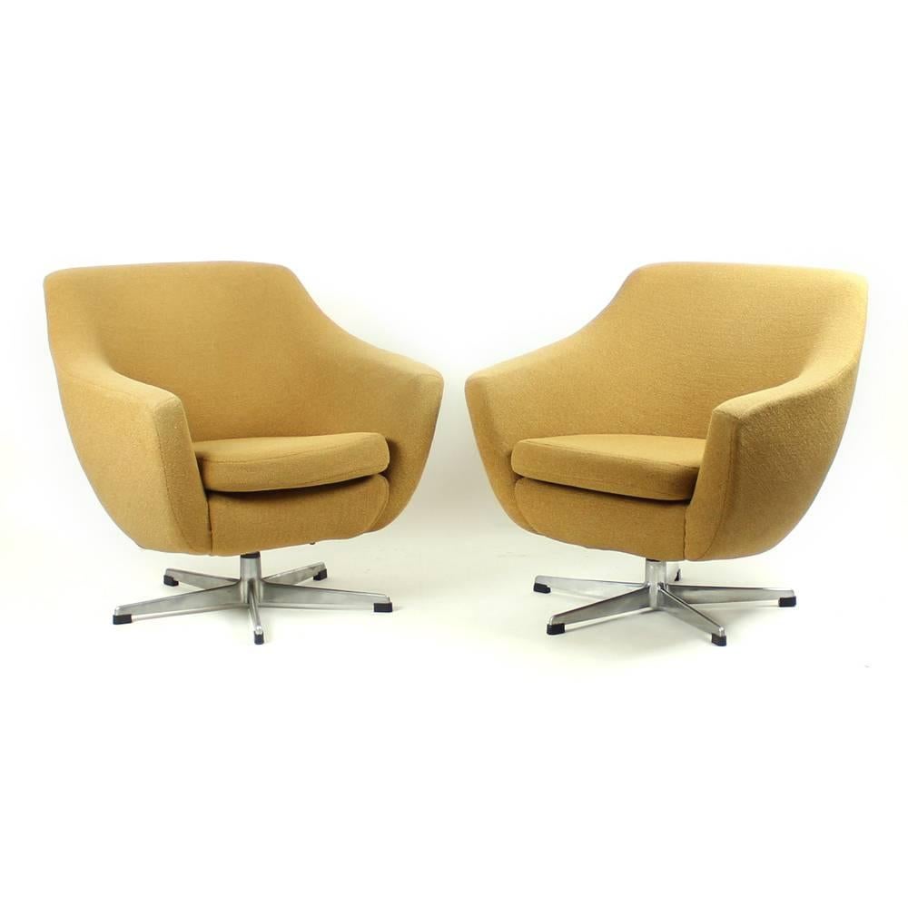 Beautiful and original. These two club chairs from 1960s are just great. They look like new and are in excellent condition. Their design is fascinating. Sleek, beautiful and very elegant. Original fabric in very good condition. These swivel chairs