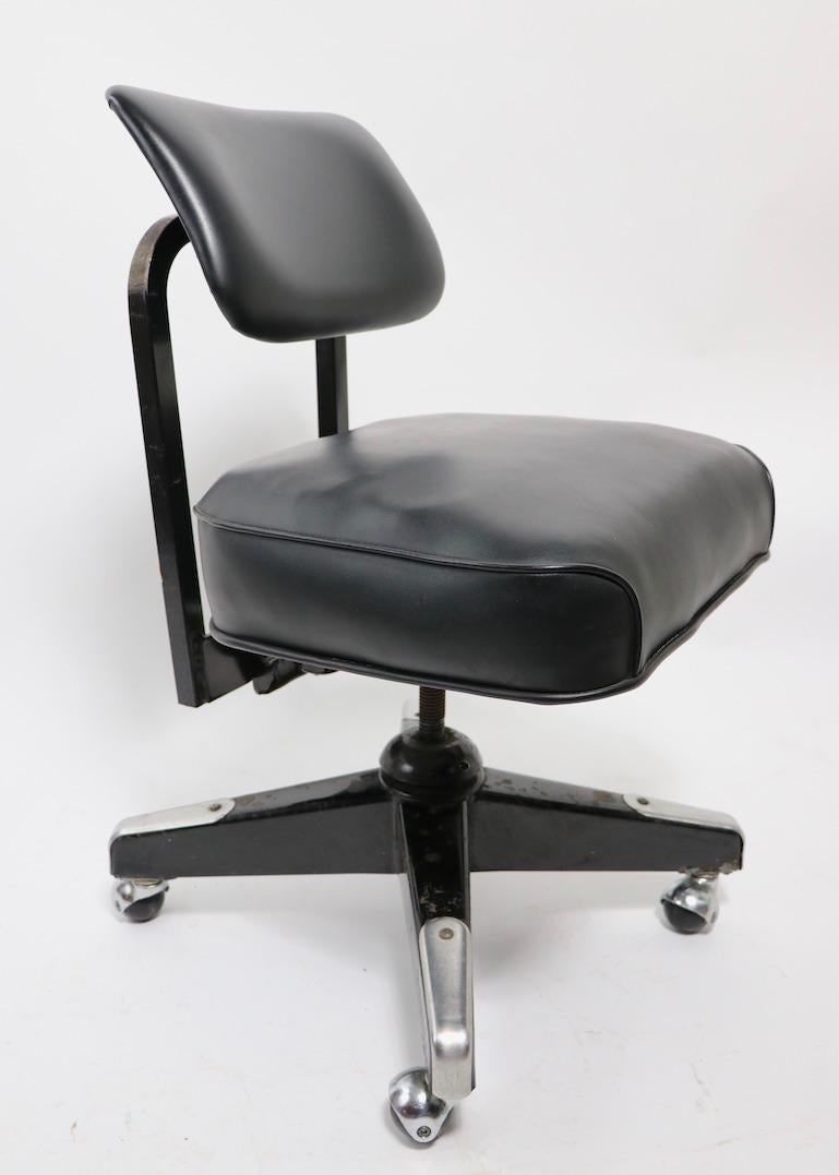 Sleek architectural swivel desk chair in black with bright steel trim. This chair swivels a full 360 degrees, the back tilts and the backrest also tilts to adjust position. The seat is adjustable in height (17- 19 inch H). Additionally, the back