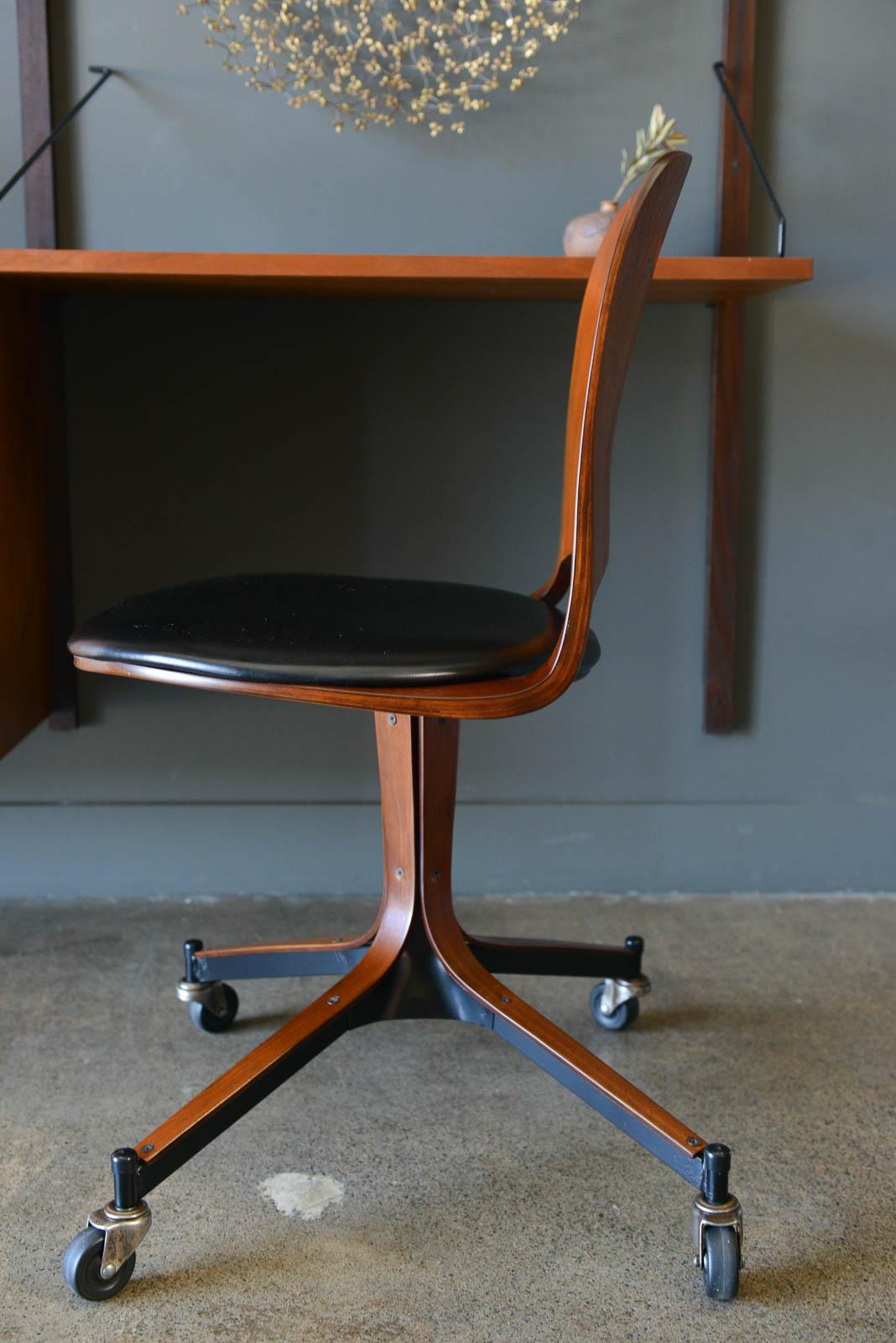 Swivel desk chair by George Mulhauser for Plycraft, 1965. Authentic bentwood swivel desk chair on original casters by George Multiuser for Plycraft, Inc. Original casters, black Naugahyde seat in good vintage condition. Wheels roll smooth and chair