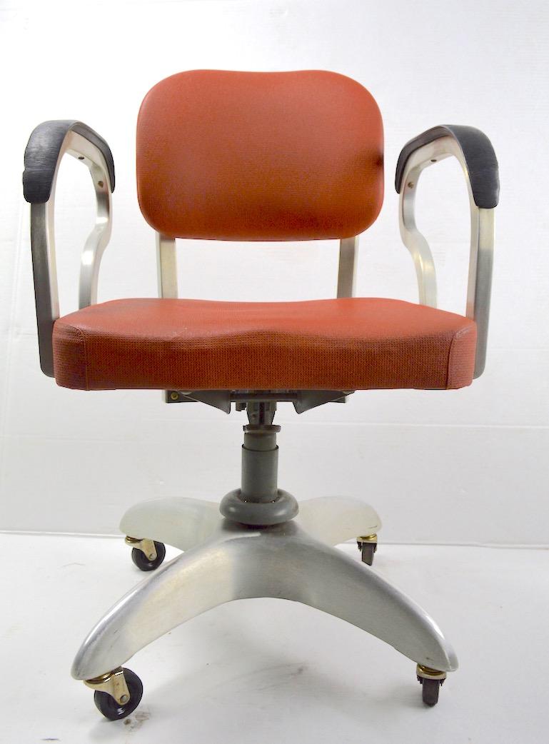 Great Art Deco swivel desk chair with adjustable tilt backrest, stylized armrests, and aluminum star base. Iconic Machine Age classic, clean original, ready to use. Black armrests have minor loss along outer edges from use, as shown. Measures: Arm H