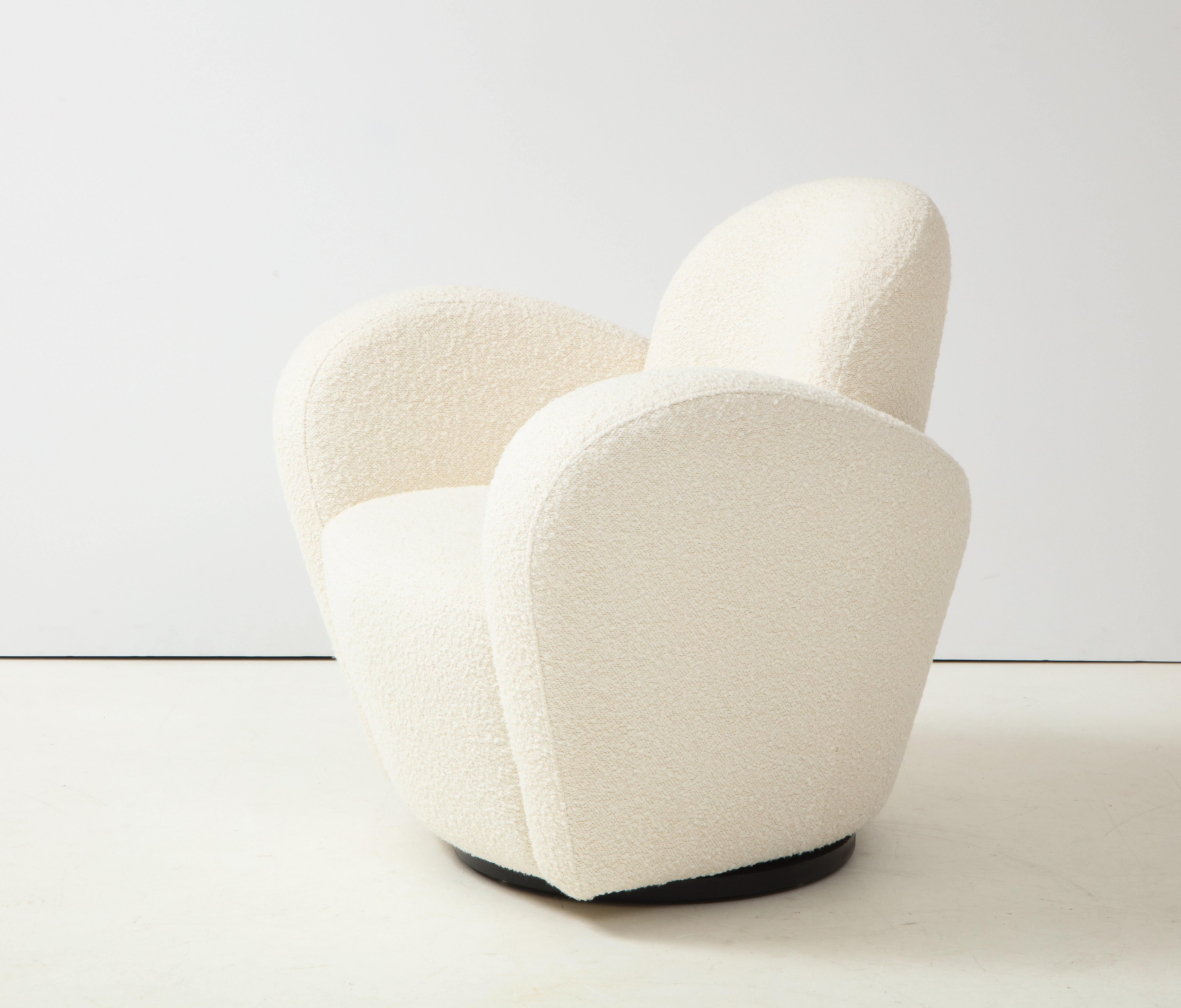 Michael Wolk swivel lounge chair fully restored and newly reupholstered in a luxurious Holland & Sherry Melissani White or ivory bouclé resting on a black wooden swivel base. This iconic and chic form consists of elegantly curved wraparound arms