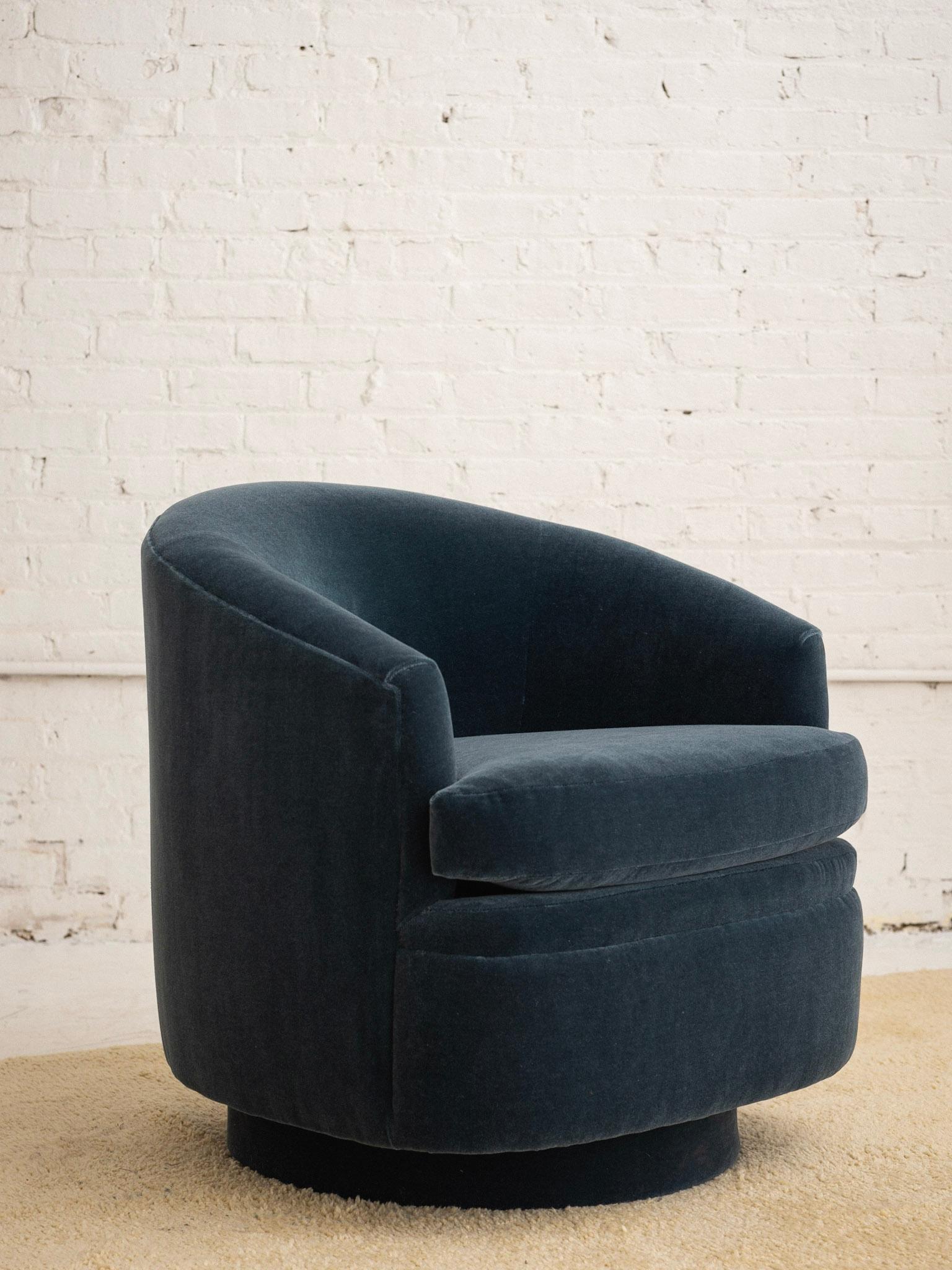 A post modern swivel lounge chair. Milo Baughman style. Newly reupholstered in a teal mohair.