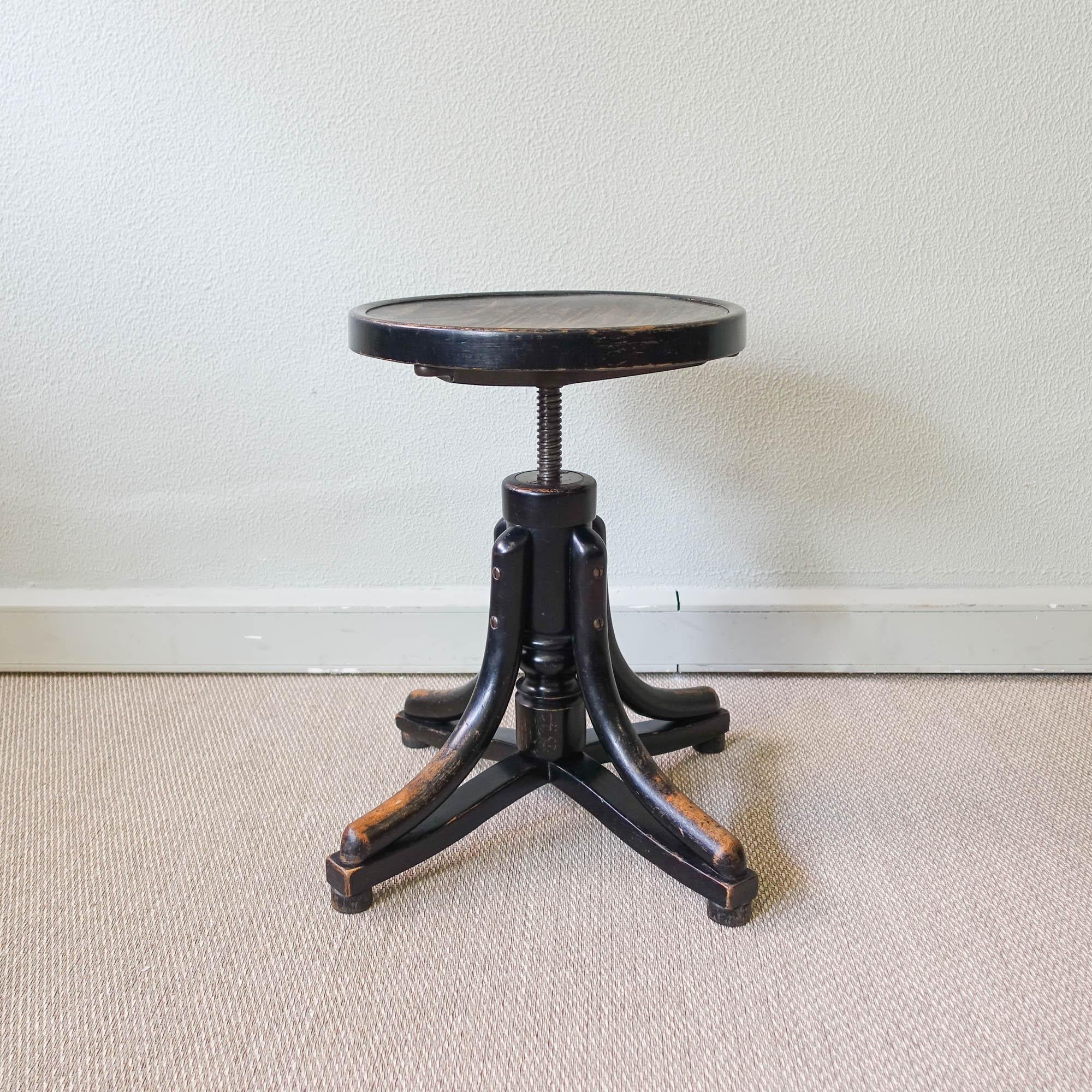 This piano stool was design and produced by Thonet, in Austria, during the 1900's. It is a rare variant of a swivel stool. Bentwood legs with turned wood vertical standard, and wood disk form seat. Seat spins to adjust height (Total H in upper