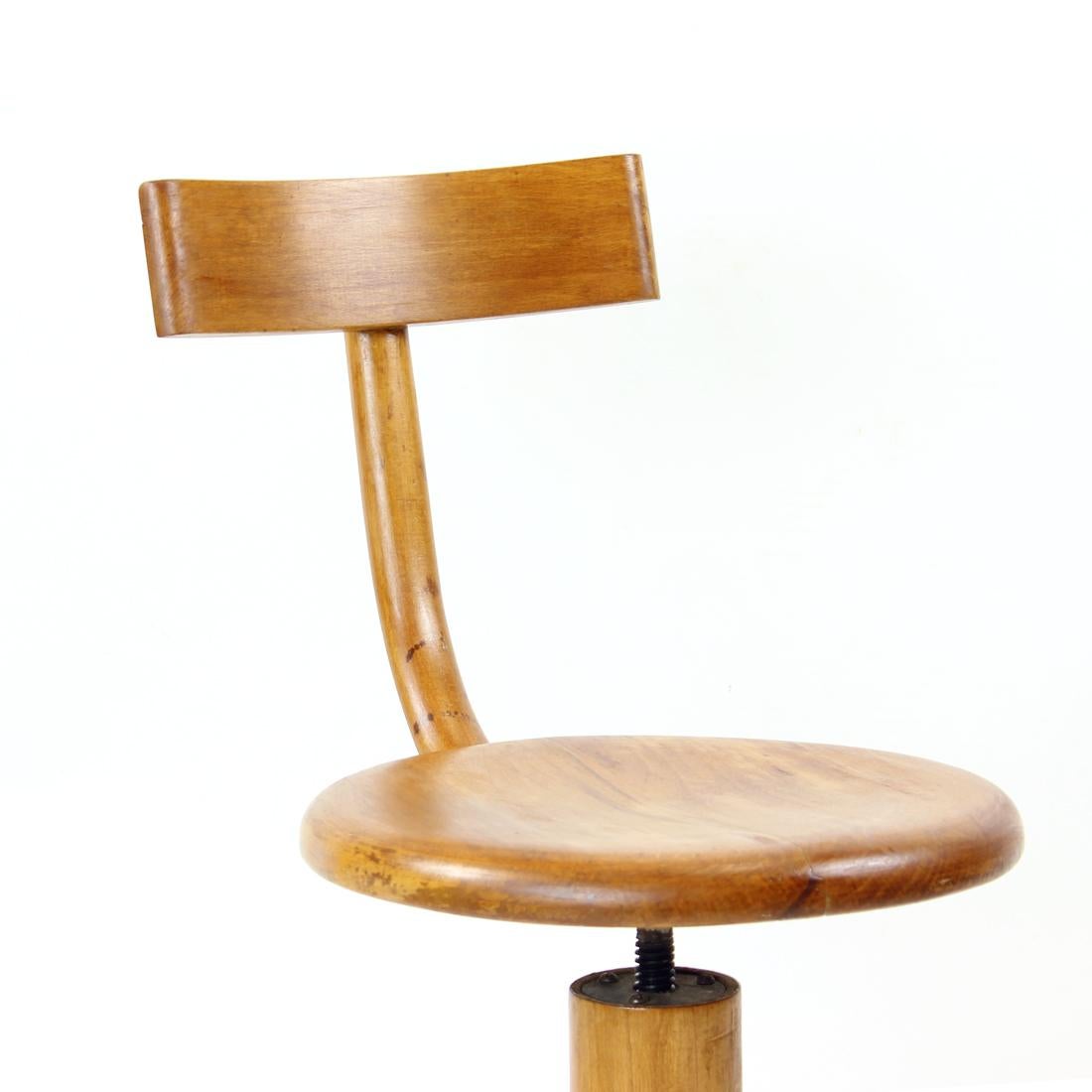 Original and unique piano stool produced with a backrest in Mid-Century Modern period of Czech design. Original design by Thonet, produced by TON in Czechoslovakia. The stool is made of hard oak wood. Hight adjustable by turning from 44cm, up to