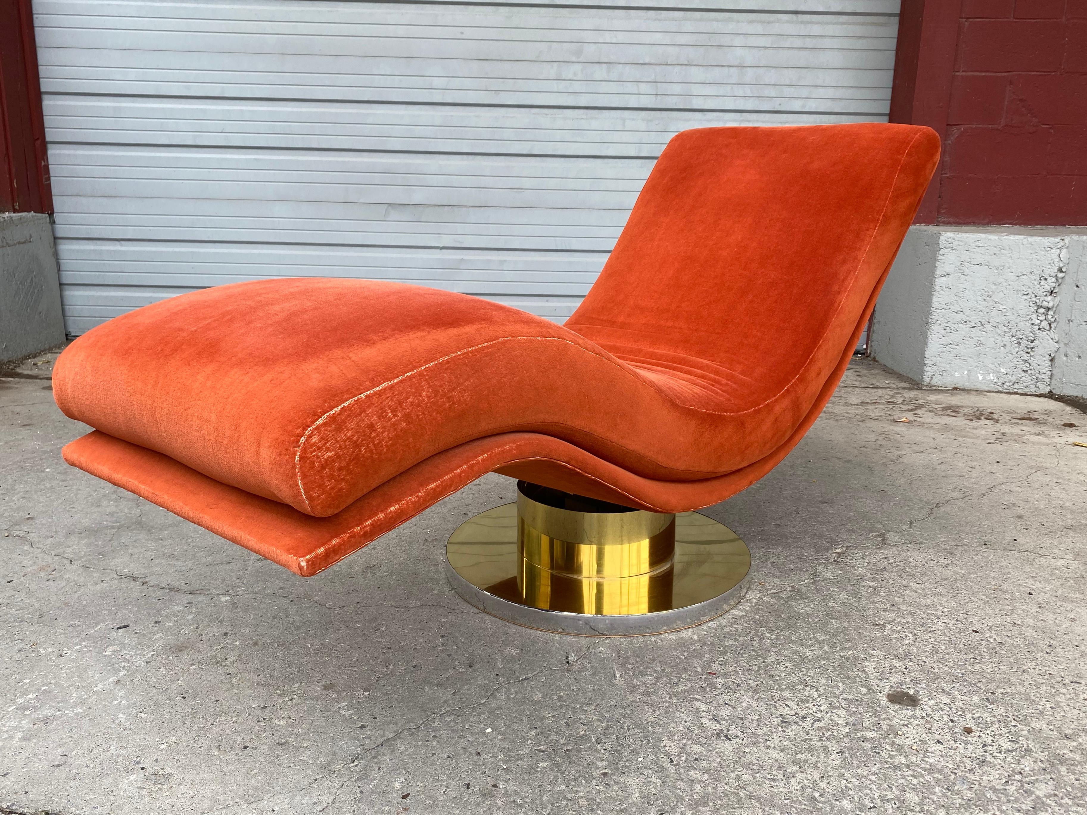 Stunning swivel rocking wave chaise lounge by Milo Baughman for Thayer Coggin with polished brass and chrome base. Mid-Century Modern. Classic modernist design, Retains original electric orange fabric, minor edge wear, also retains original Milo
