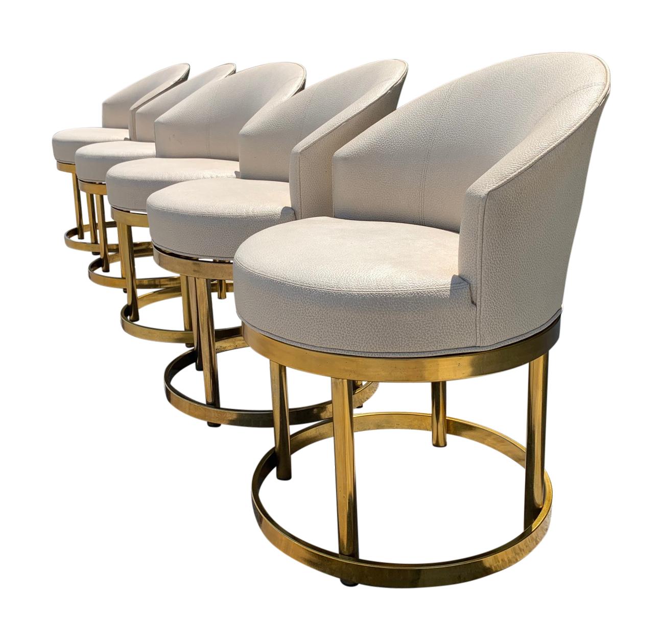 Swivel stools on brass bases in the manner of Milo Baughman, Mid-Century Modern.
