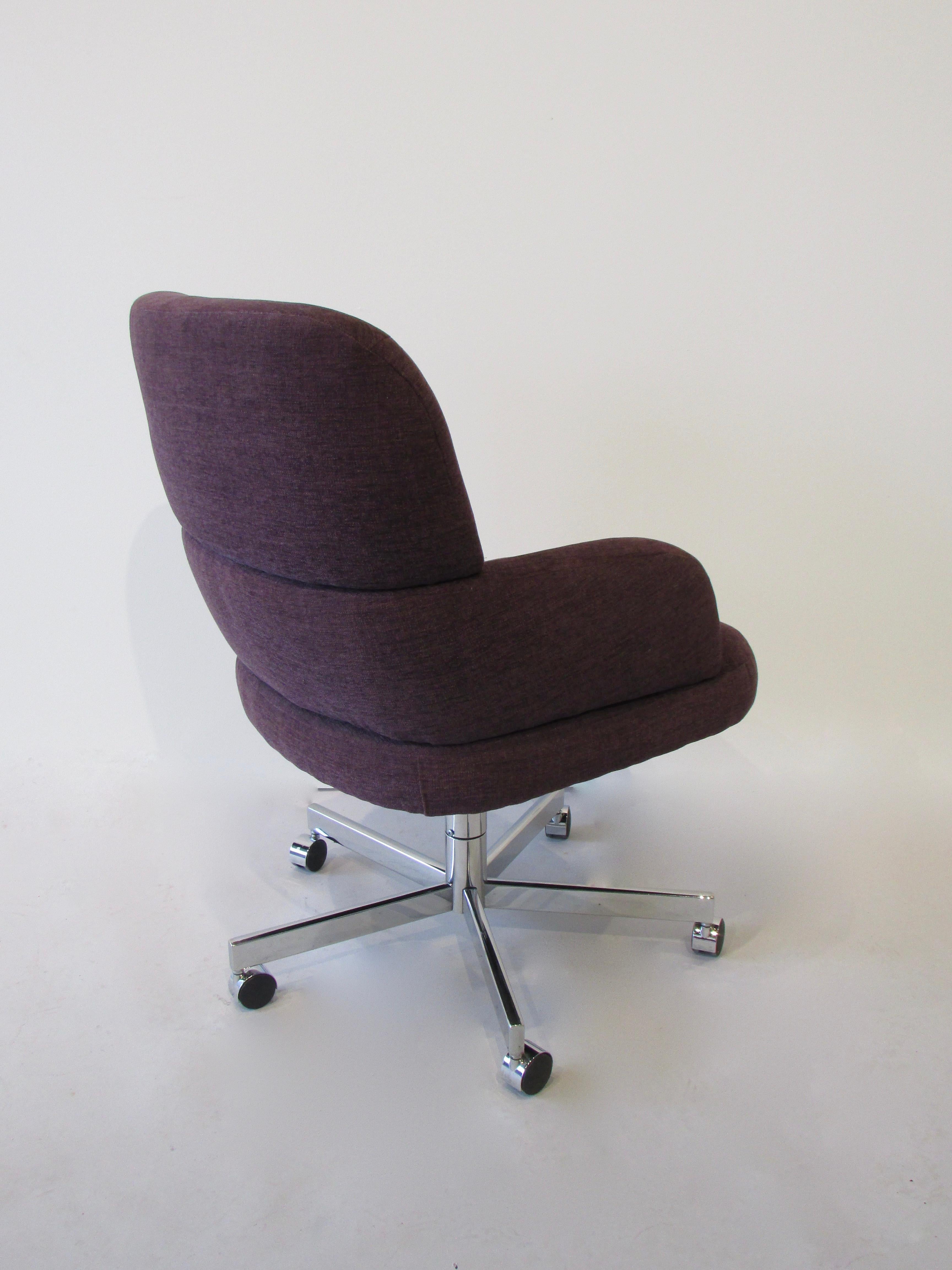 Swivel and tilt office desk chair on casters. Purple textile in channeled style upholstery.