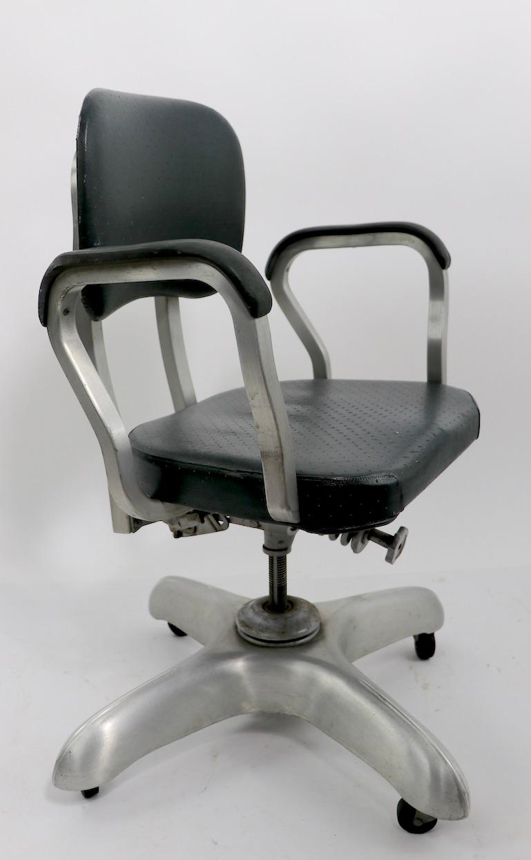 Architectural design, commercial quality swivel, tilt desk, office chair by Good Form, General Fireproofing. This example has a four leg aluminum base, with vinyl upholstered seat and backrest. The backrest both tilts and reclines tom add to the