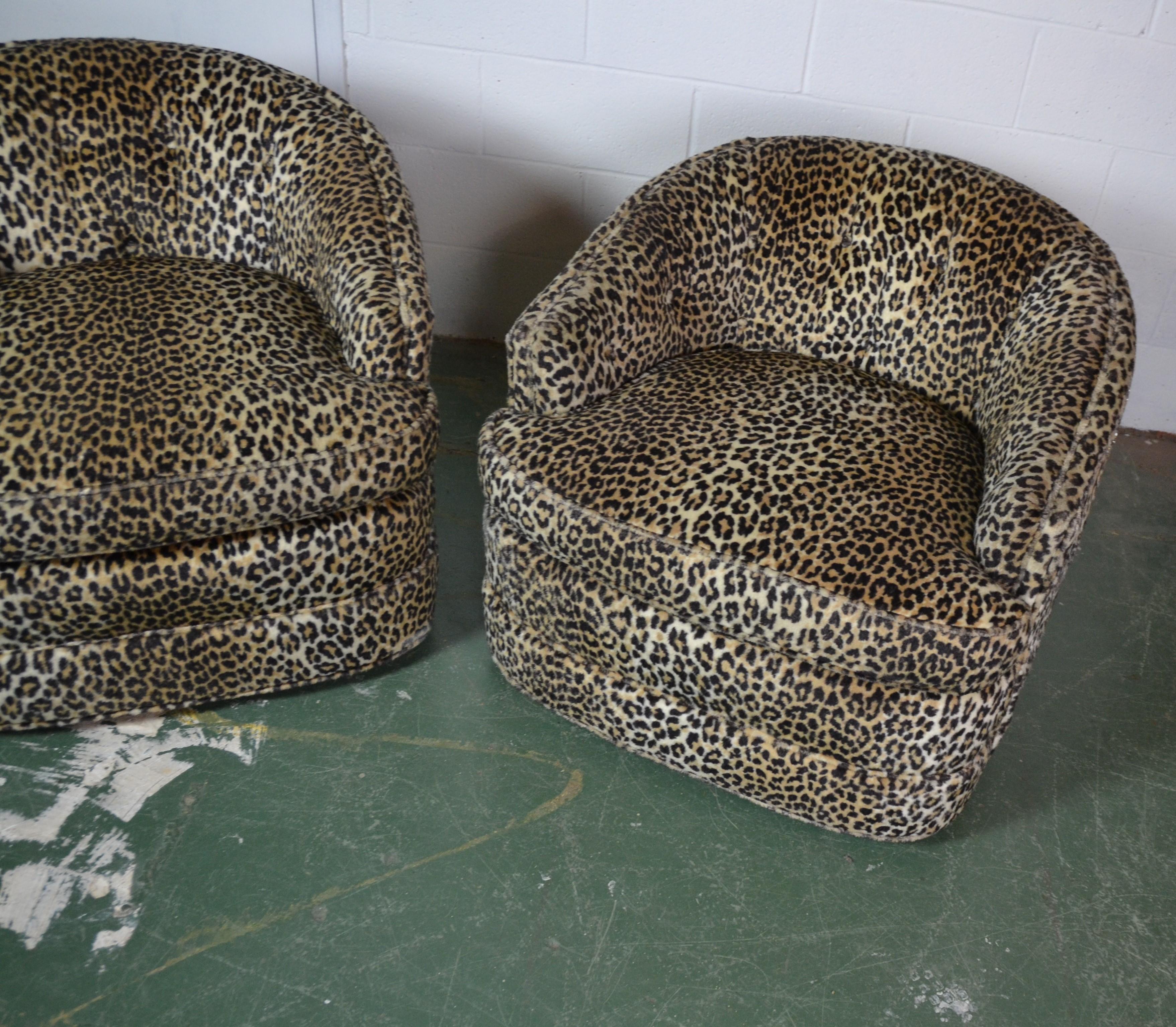 Pair of vintage Henredon Shoonbeck lounge chairs features extremely soft leopard upholstery and removable cushions. The low sitting swivel design with angled armrests provides maximum comfort in any seating arrangement.