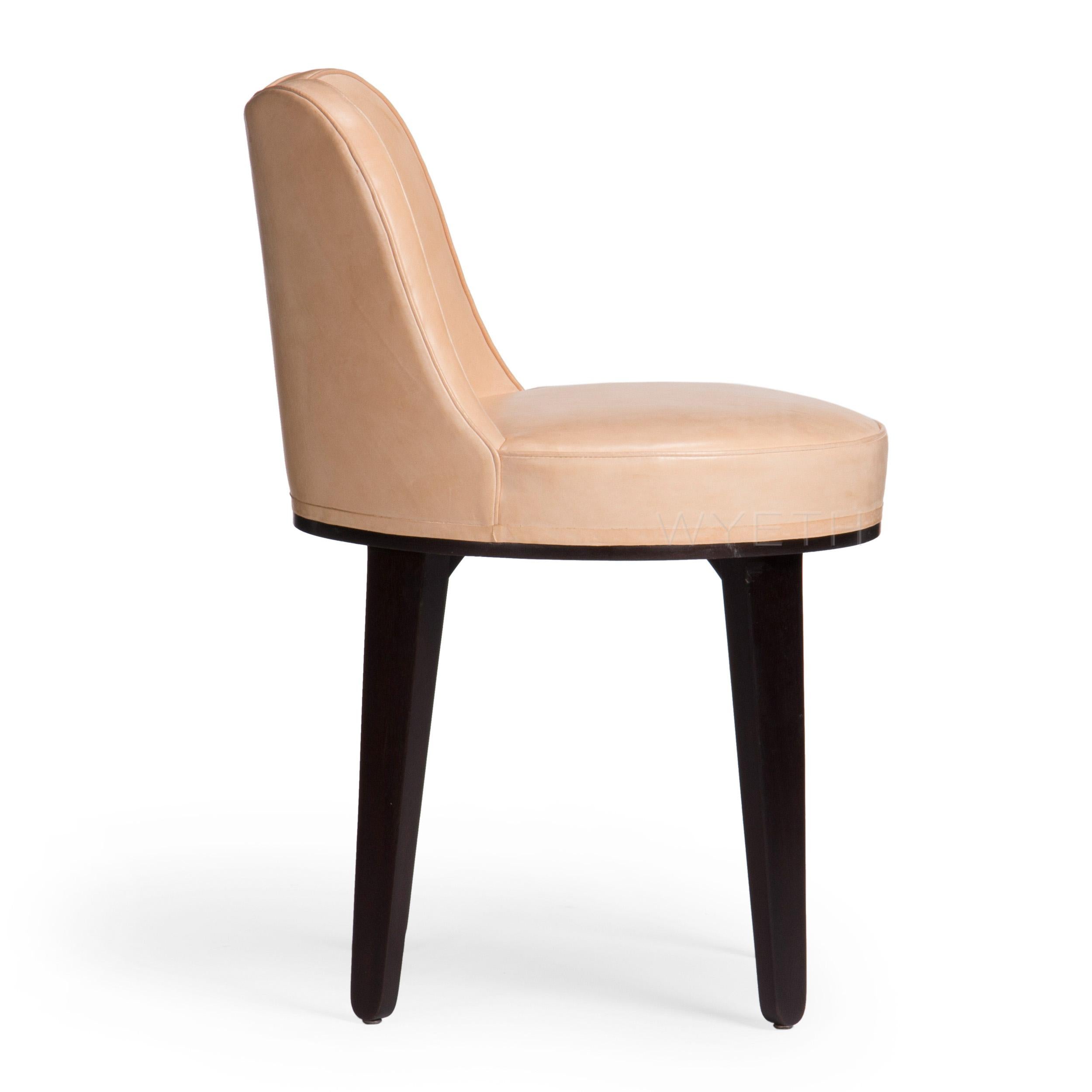 A small sway backed swivel chair with hairpin, ebonized mahogany legs. Newly upholstered in natural waxed leather.