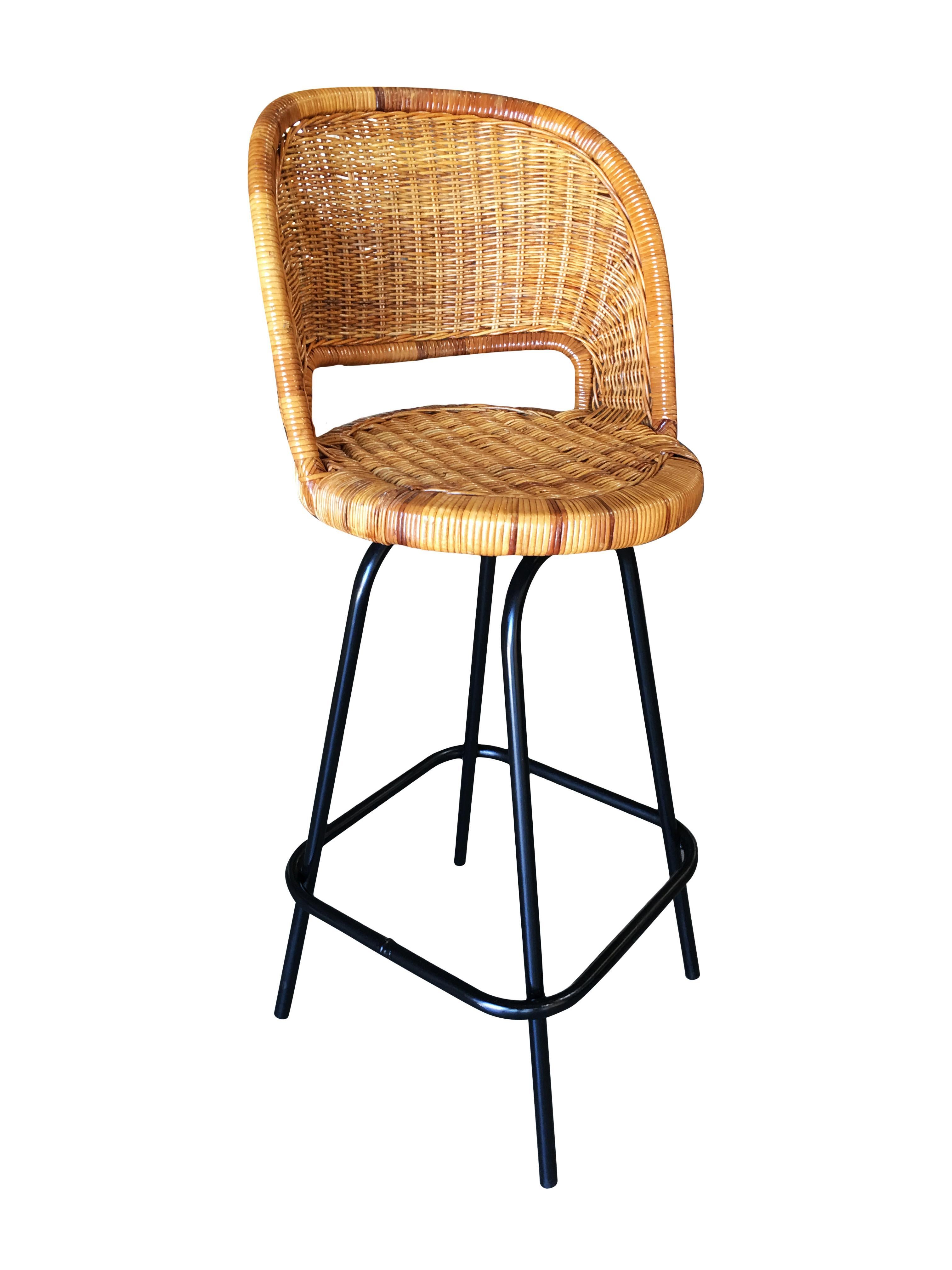 Set of 3 Swivel Wicker Bar Stools in the Seng of Chicago Style featuring a Woven Wicker seat and black enameled steel base. All of them feature swivel bases. The stools are in excellent condition and the swivel action functions perfectly. Circa