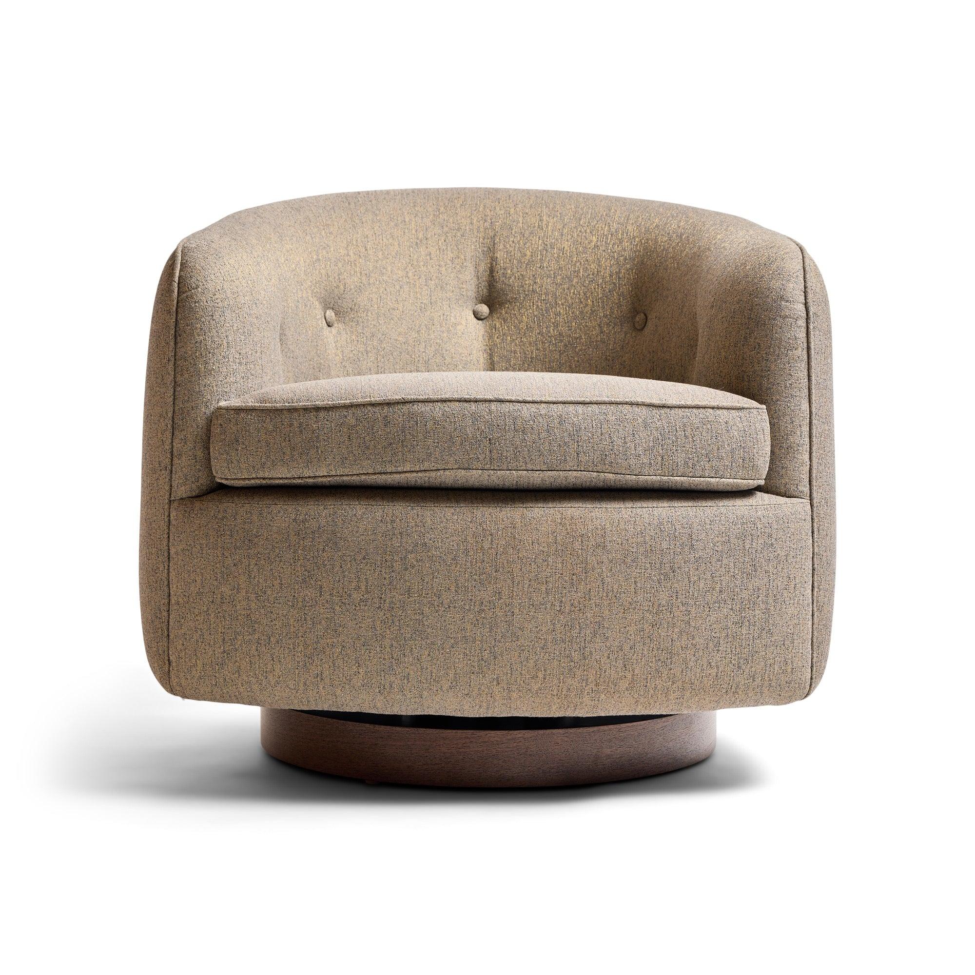 A sculptural and well balanced swiveling and tilting upholstered barrel-back lounge chair having encircling forms rising from round walnut disc bases.
