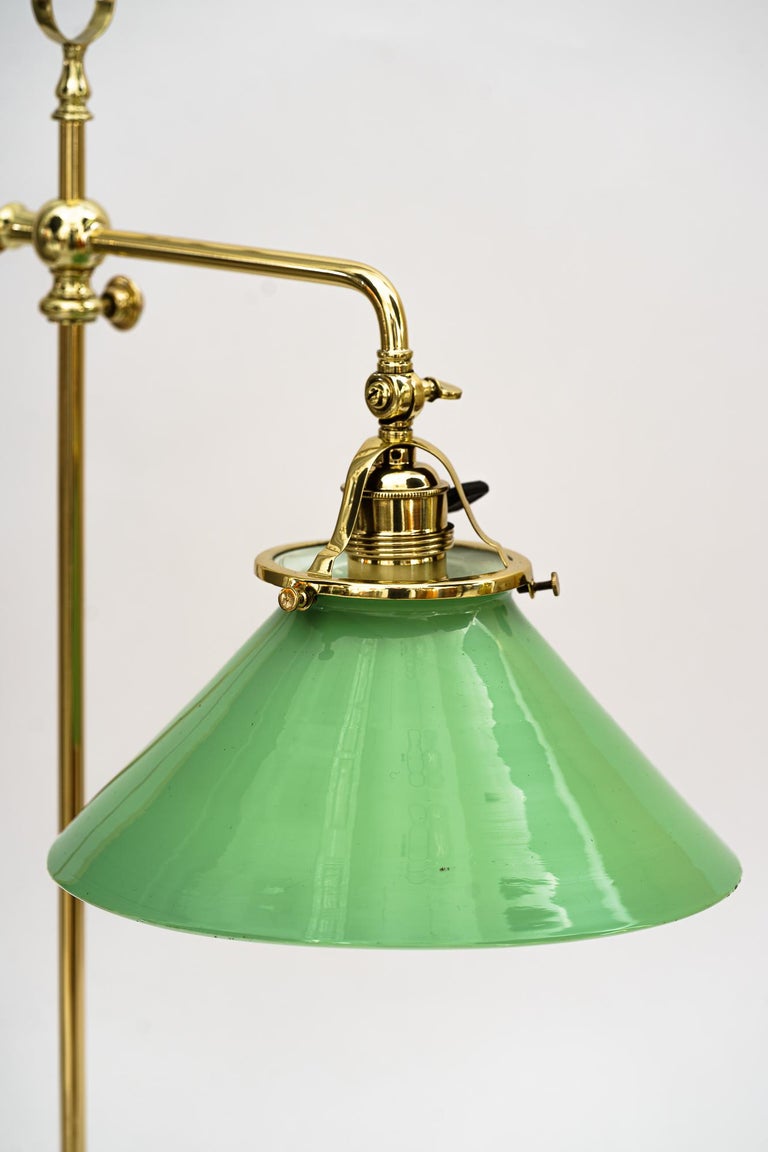 Swiveling Art Deco table lamp vienna around 1920s
Brass polished and stove enameled
Original opal glass shade.