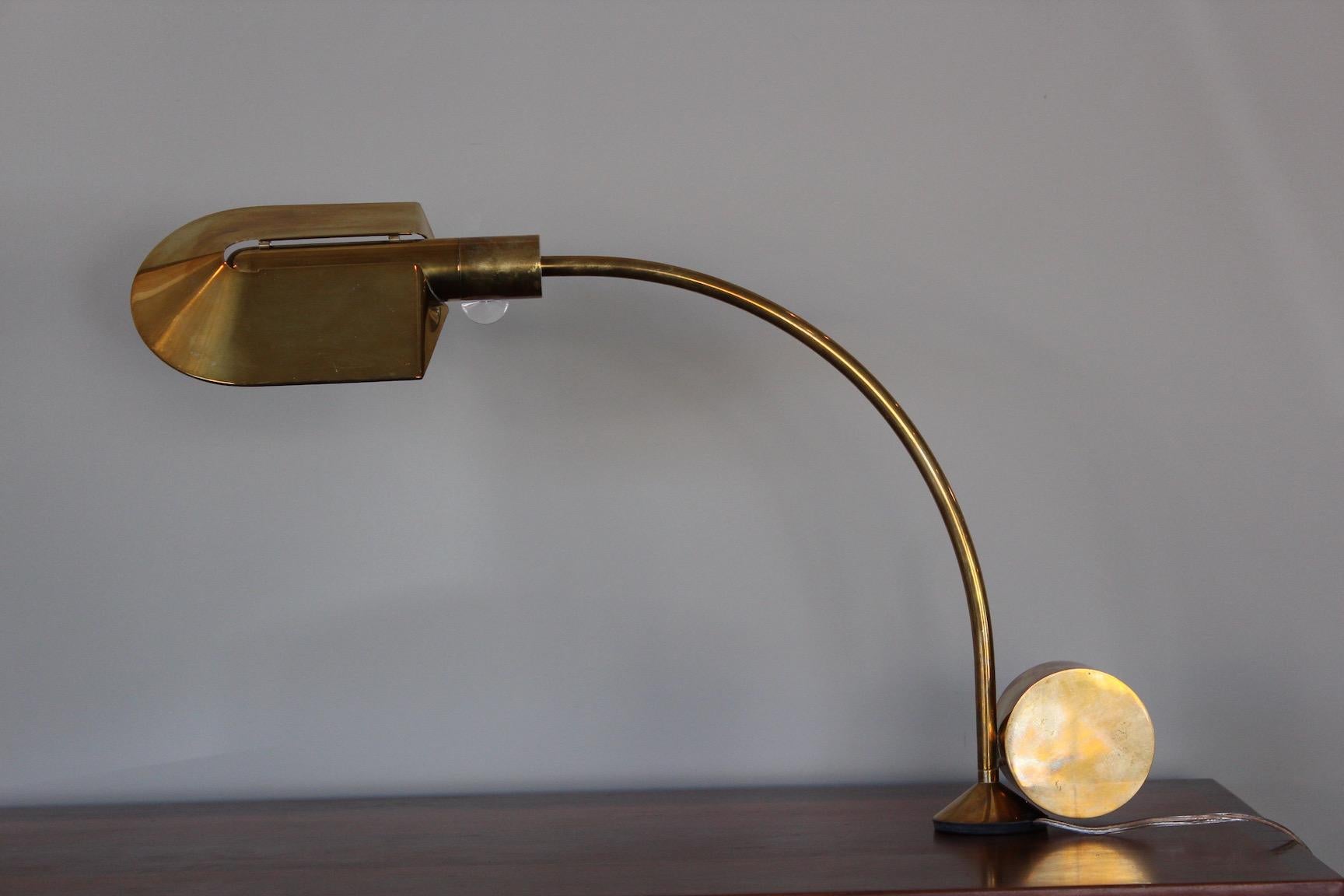 A swiveling brass desk lamp designed by Cedric Hartman.