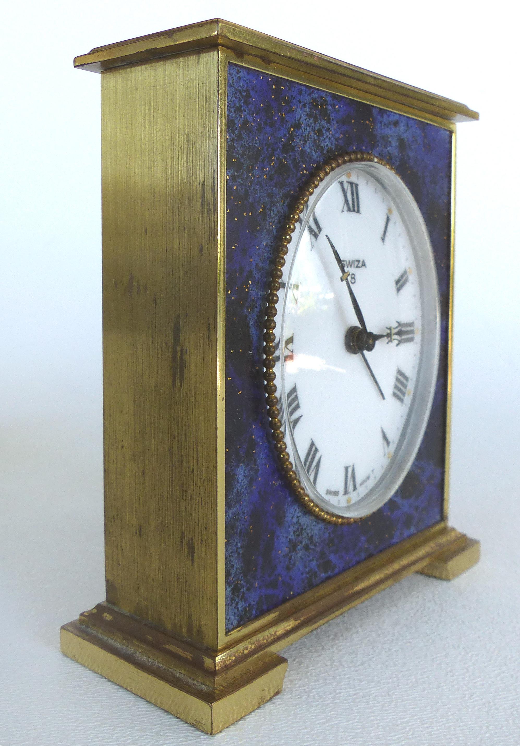 Offered for sale is an elegant Swiza 8 Swiss-made lapis lazuli and brass winding carriage clock.  
The clock keeps time, however. the sweep seconds hand does not work. 
