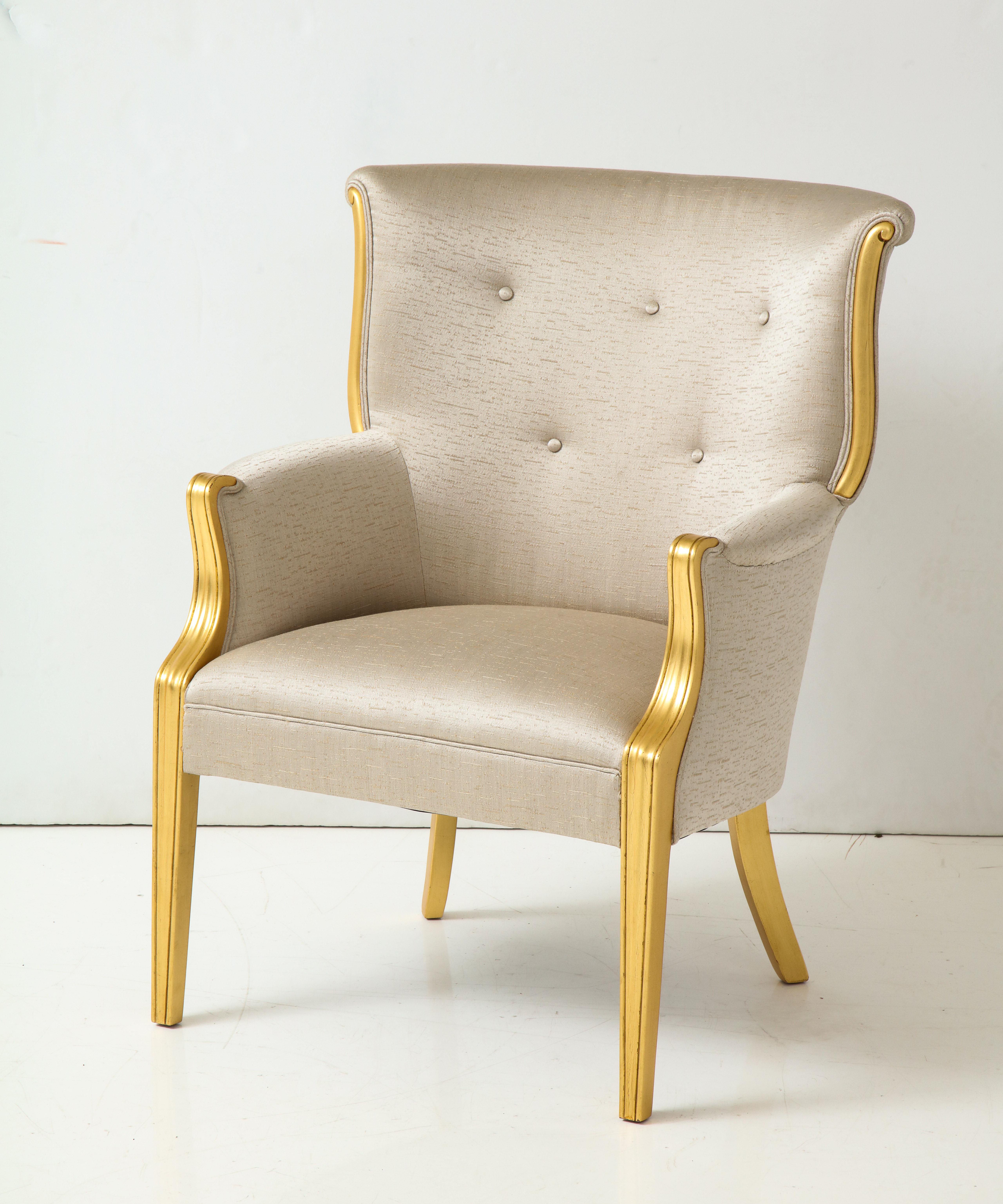 1940s Art Deco club chair with a seductive gilded carved wood frame, upholstered in a heavy silk/cotton silver fabric with a gold thread underlay. Mint restored.