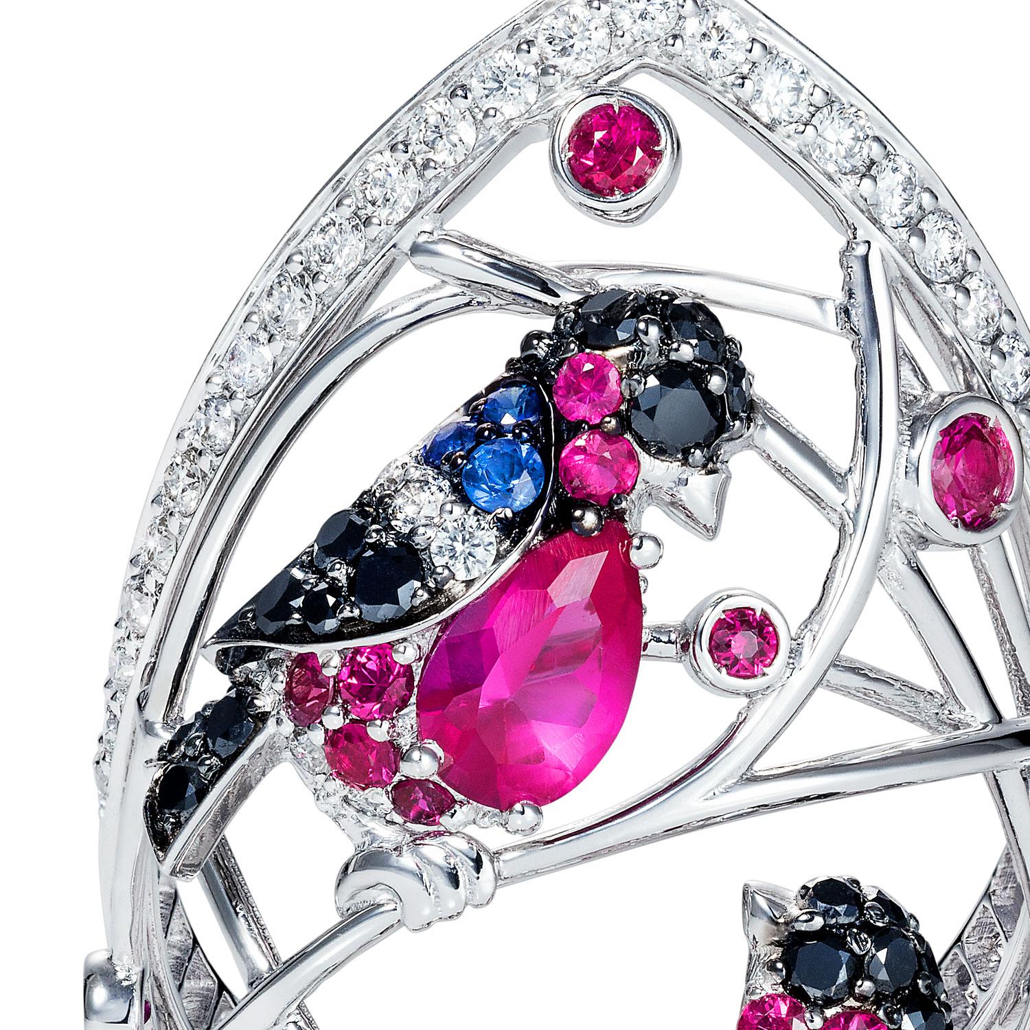 This exquisite Winter Birds ring is a masterful piece of artistry and craftsmanship, embodying elegance and nature's charm. The design features a delicate openwork cage of gleaming white gold, adorned with a graceful lattice of branches. Nestled