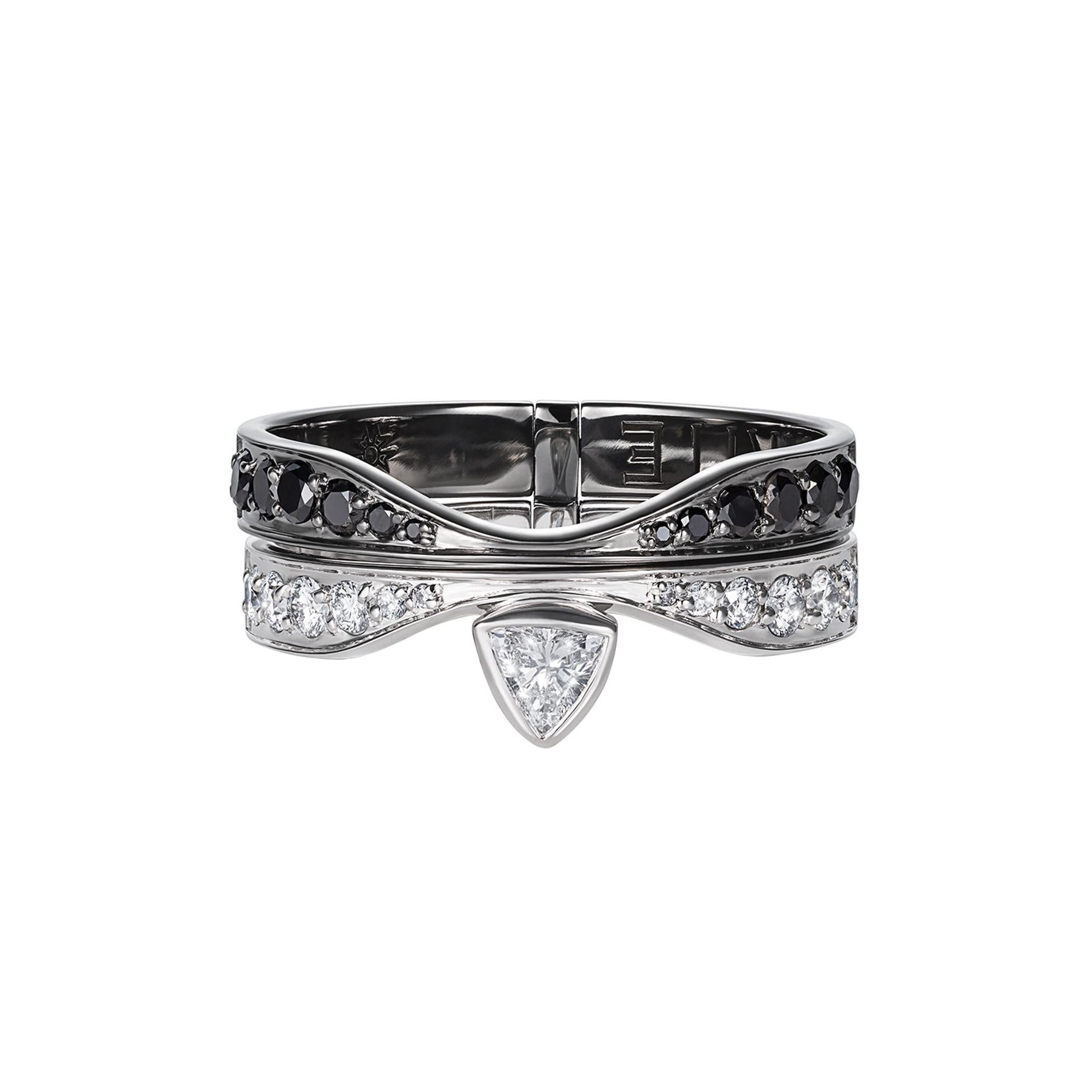 The transformer ring has two positions and can be used as a wedding ring.
The first position features a triangular diamond nestled between the row of white and black diamonds. The second, a triangular diamond below the row of white and black