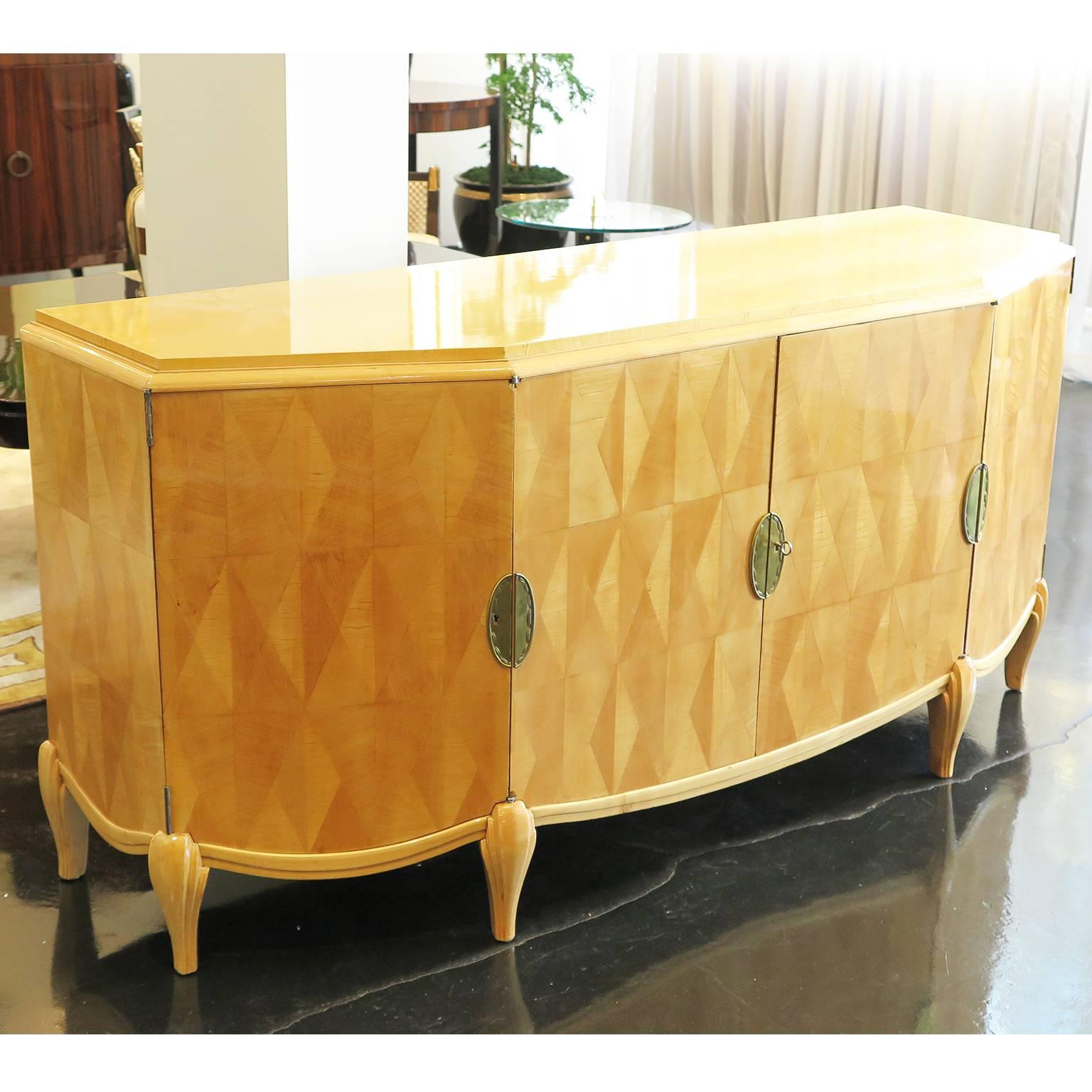 Beautiful 1920s sideboard by Pierre Lucas with an angled sycamore frame. Citron wood diamond parquetry decorates all four doors of this piece. Four oval relief brass hardware as keyholes with a scalloped design. Six beautiful carved legs support the