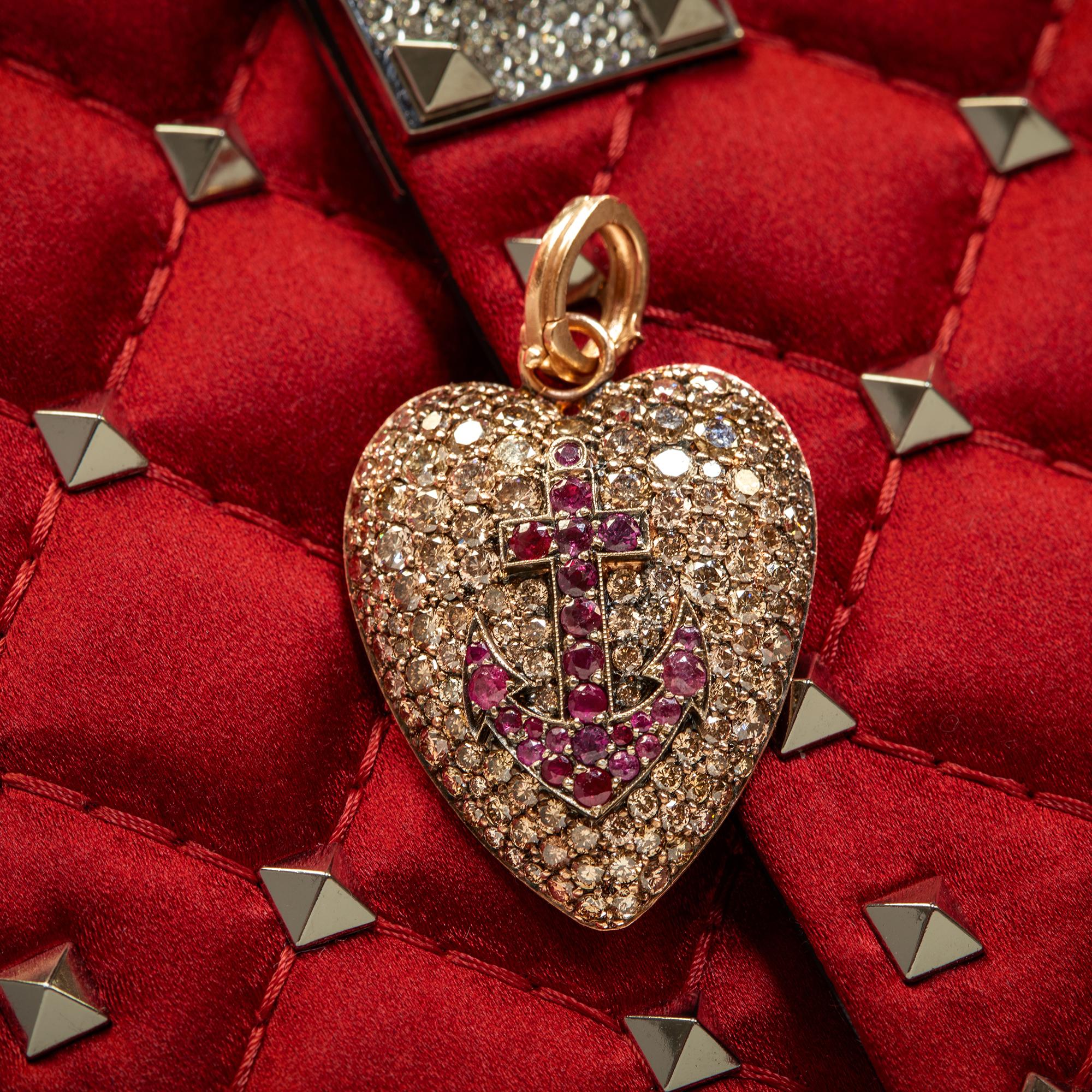 A symbol of steadfastness and love, this heart-shaped anchor pendant is encrusted with champagne diamonds and lively red rubies.

18K rose gold
1.24 carats of rubies
5.88 carats of champagne diamonds
Anchor is 1.6 inches long
Anchor is 1 inch wide