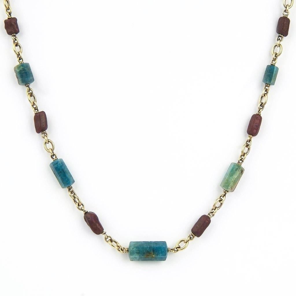 Tumbled aquamarines and rubies in graduated sizes tell a sophisticated color story in this refined bead necklace. 18K yellow gold with 62.96cts of aquamarines and 52.99cts of rubies.
