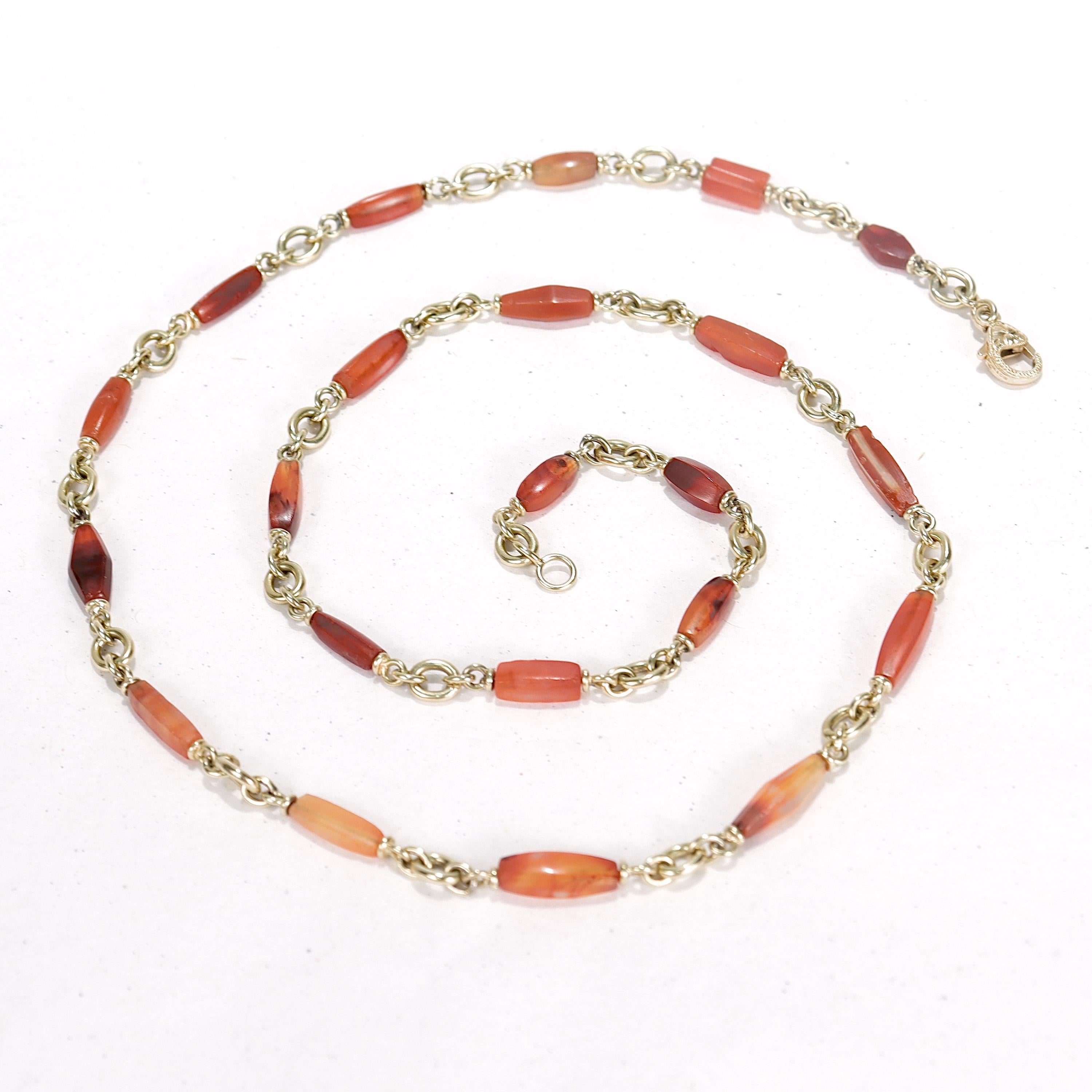 A fine gold and carnelian bead bullet chain necklace.

In 18 karat yellow gold.

With a tumbled, wheel polished carnelian gemstone beads in graduated lengths and oval gold links.

By Sylva et Cie, Sylva Yepremian's renowned Los Angeles-based jewlery