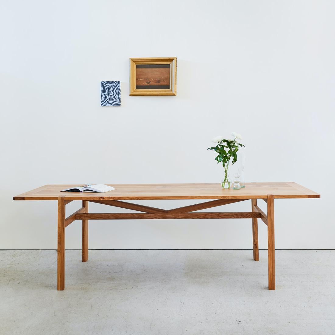 Marrying a rustic, truss-style structure with a lightweight form, the Sylvan table brings a contemporary touch to a classic farmhouse design.

The tabletop features breadboard ends which runs cross-grain to the main panel, adding both stability