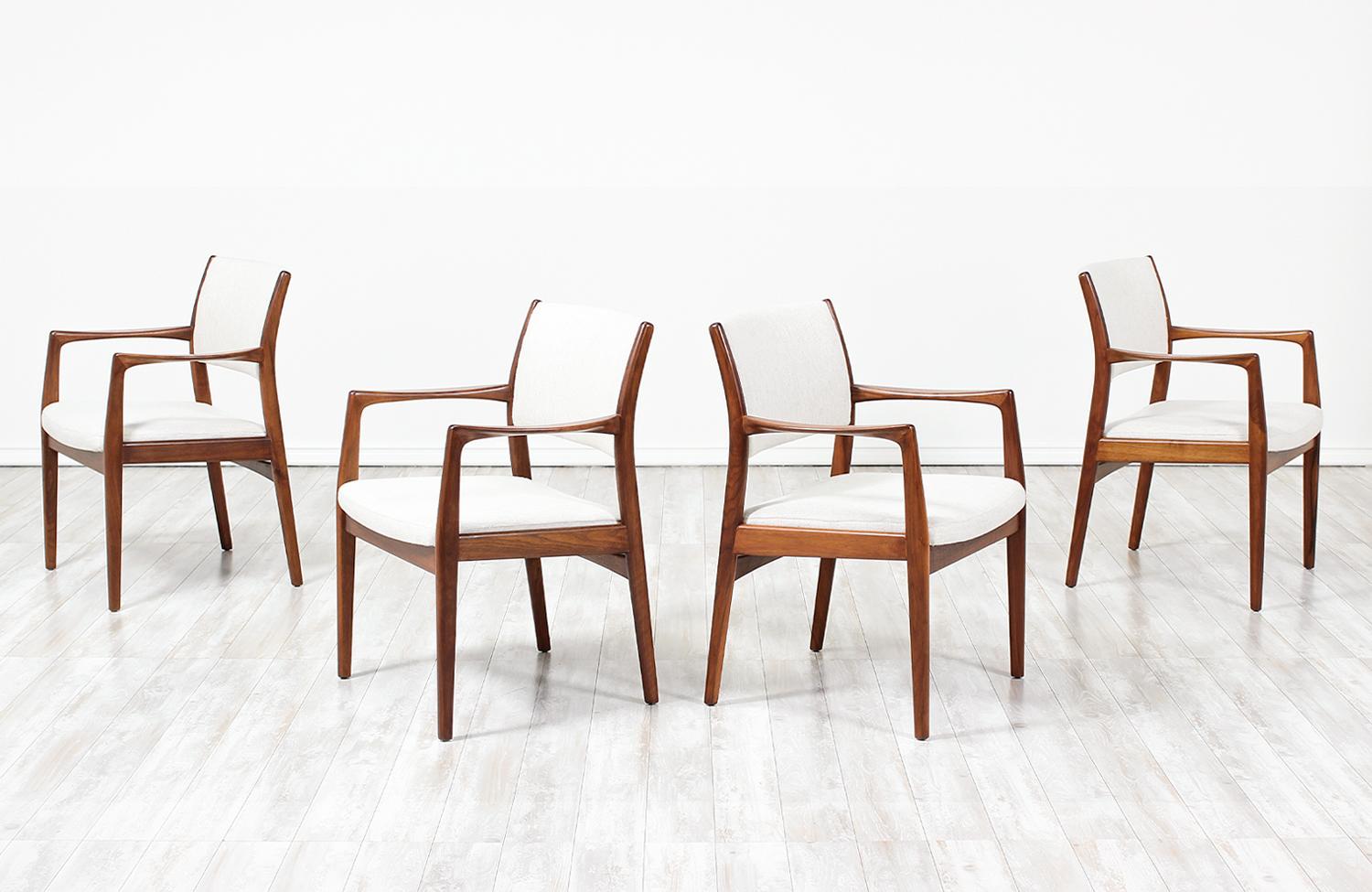 A sleek set of four model-431 dining chairs by Sylve Stenquist for DUX of Sweden, circa 1950s. This gorgeous design features four armchairs with a solid walnut wood frame and new upholstery in soft, white tweed fabric. The clean lines and