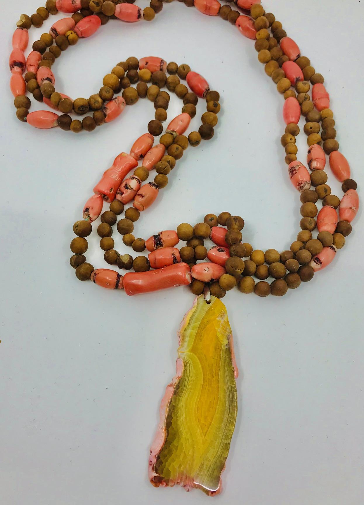 The stunning vintage salmon Coral with wooden beads 3 strand Necklace with a Large yellow Agate pendant.
The vintage Coral collected over number of years , no longer available for harvesting due to coral reef devastation , by pollution ,ocean
