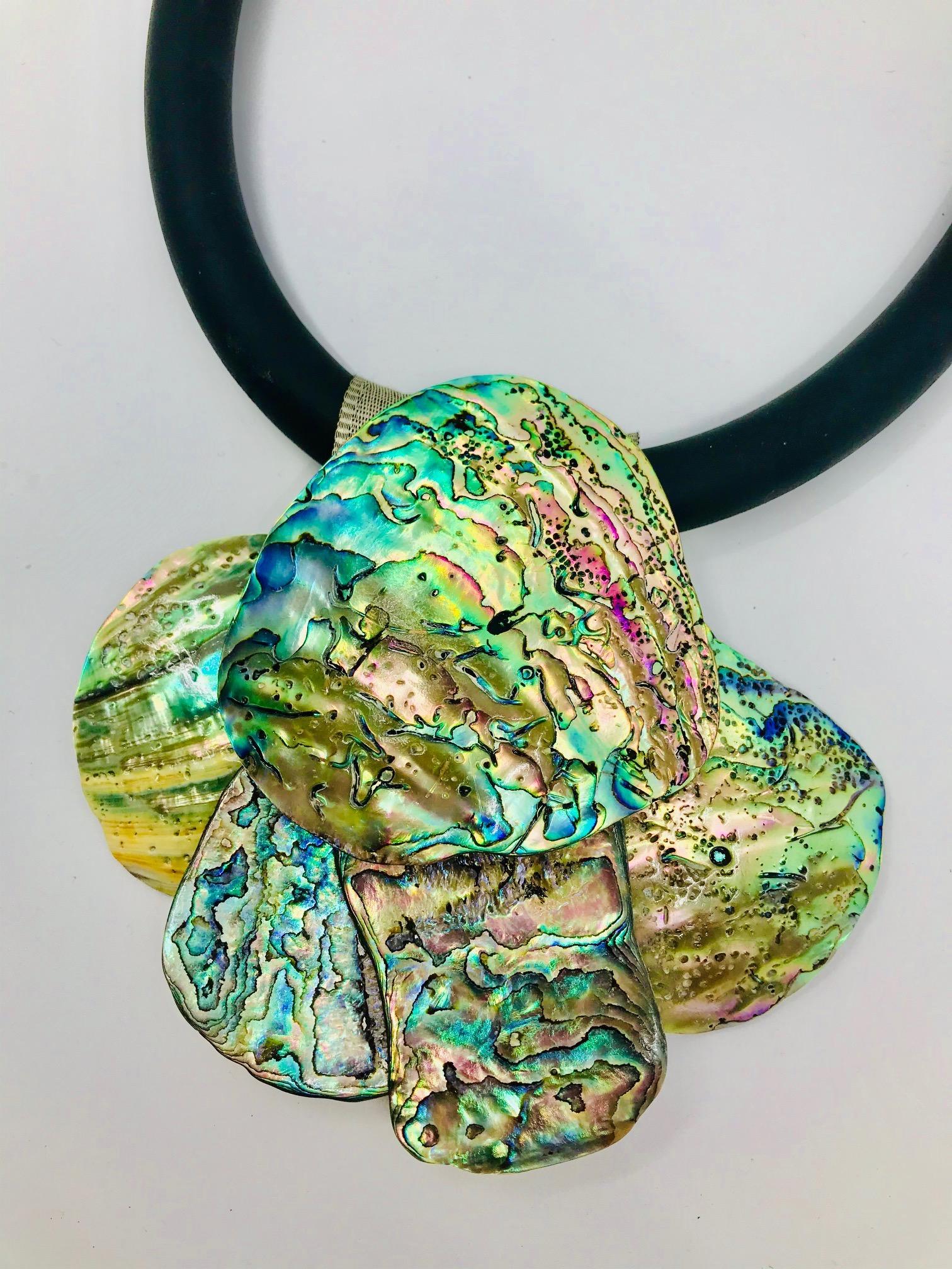 Haliotis /Paua Pendant on black rubber tube, consists of 5 organic shape large Paua shell petals. The 15 mm rubber tube is finished by tubular silver clasp. Paua is a shell from New Zeland.

Haliotis / Abalone / Paua nacreous  shell is one of the