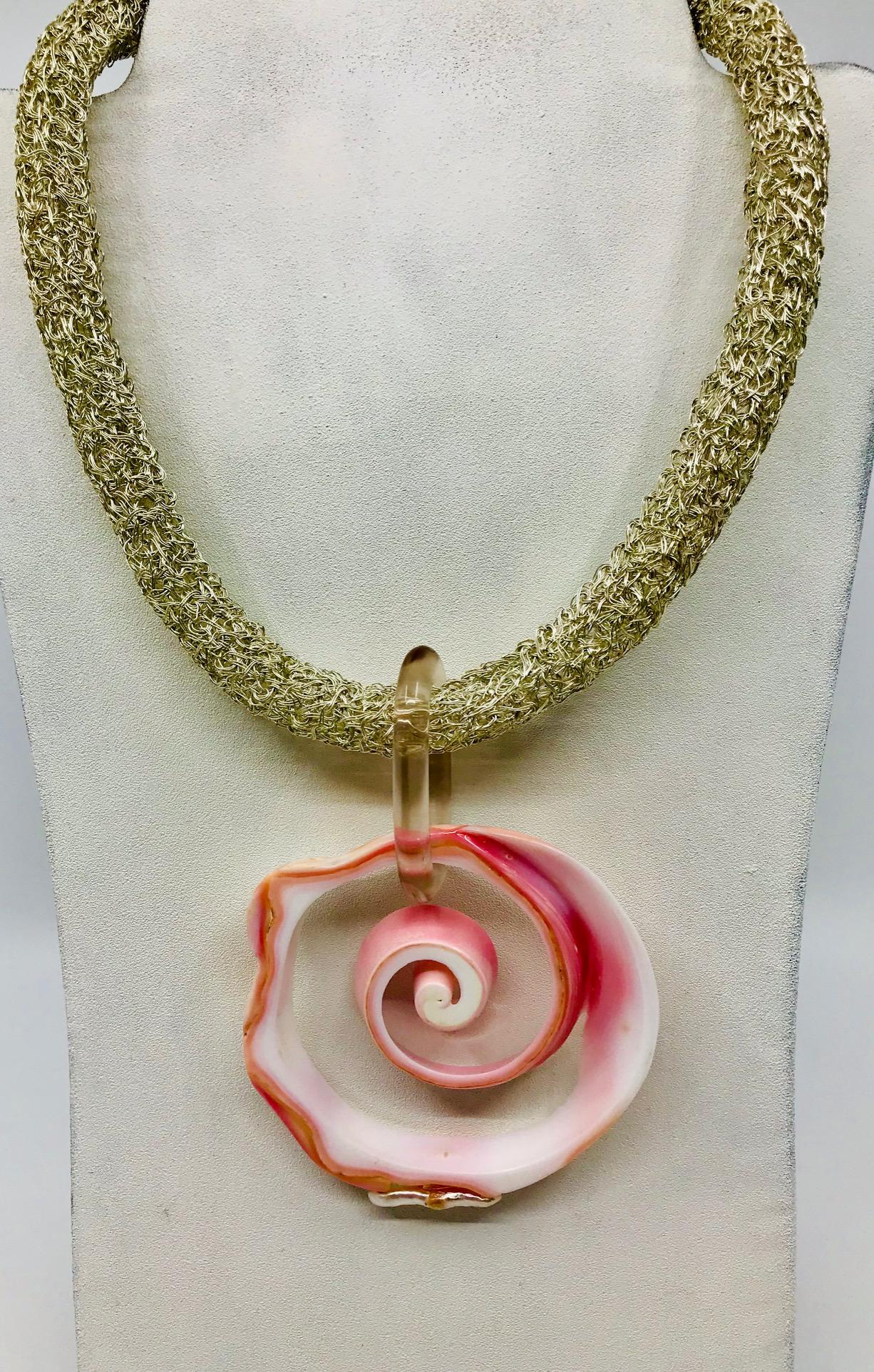 
Pink Conch Pendant on Chocker Necklace, consists of cross cut  of a Conch shell, with added enhancement of a reborn fresh water pearl.
Pink Conch shell is native to Caribbean Sea. The shell is large and thick with porcelain like surface, it grows