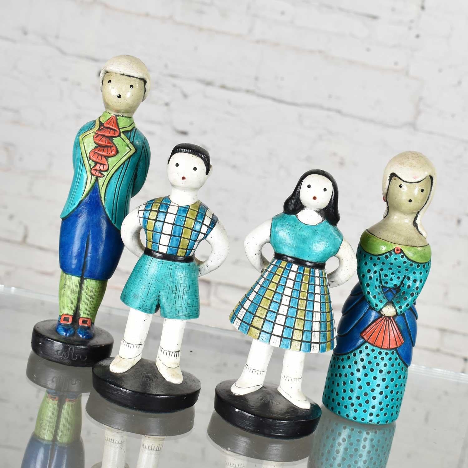 Sylvia hood original idyllic family set of four man, woman, and 2 children. These iconic figurines bear her logo indicating their rare authenticity. They are comprised of Extone (A material much like chalkware) elegantly painted with turquois, royal