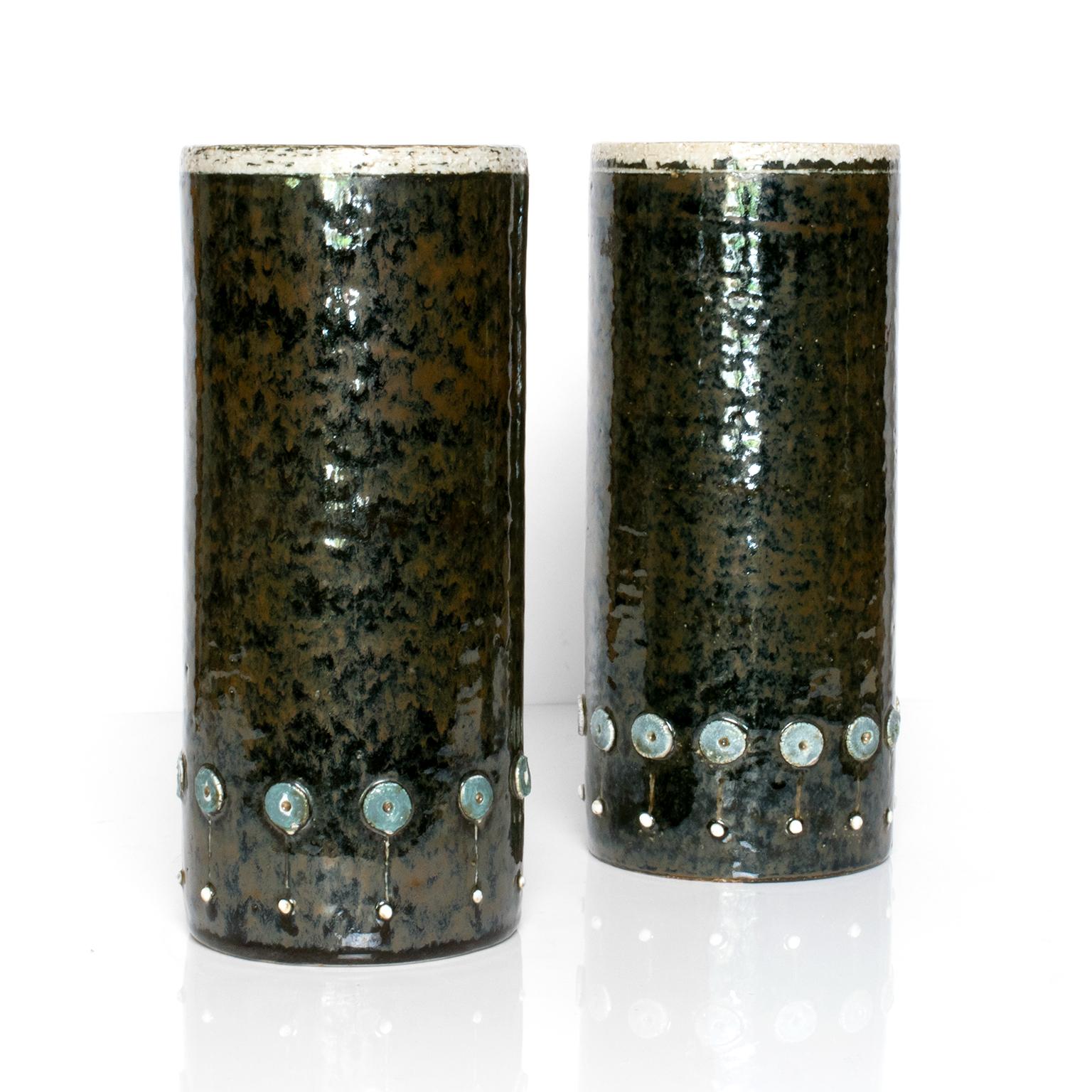 A pair of tall Scandinavian Modern mid-century ceramic studio vases with raised elements and finished in a dark glaze by designer Sylvia Leuchovius for Rorstrand, Sweden.

Measures: H 10