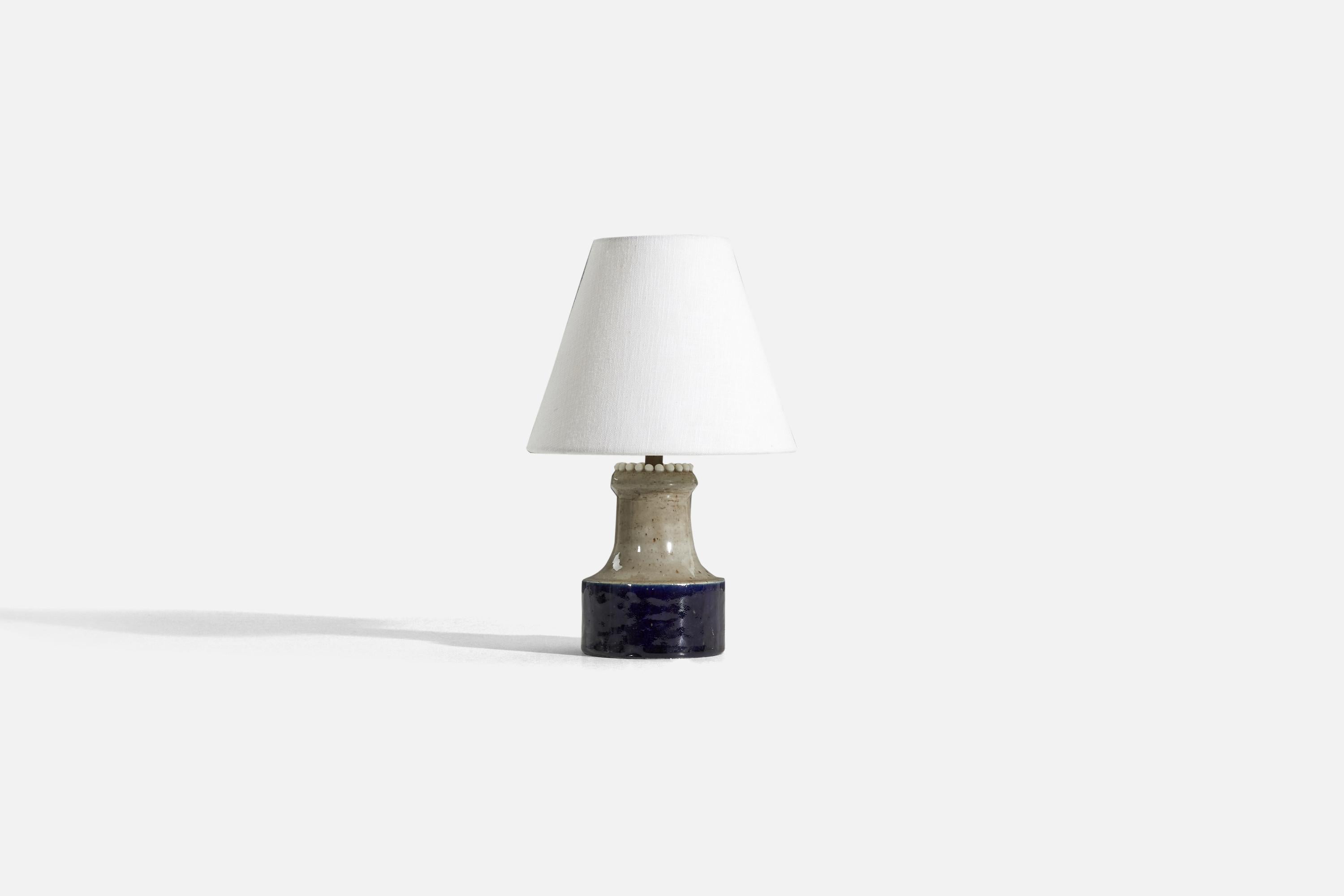 A blue and beige, glazed stoneware table lamp designed by Sylvia Leuchovius and produced by Rörstrands, Sweden, c. 1960s. 

Sold without lampshade. 
Dimensions of Lamp (inches) : 8.4375 x 4.25 x 4.25 (H x W x D)
Dimensions of Shade (inches) : 4