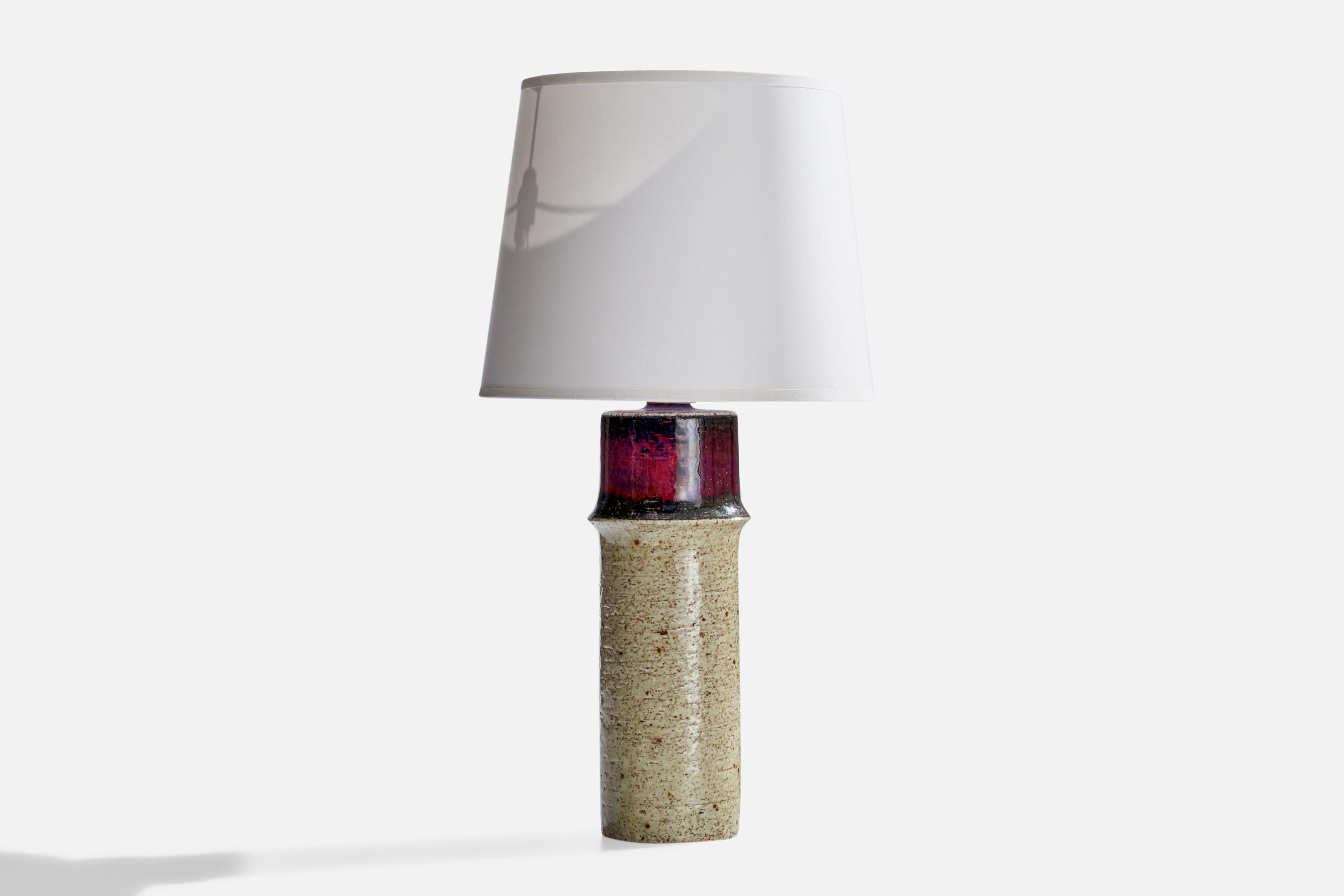 A grey and purple-glazed stoneware table lamp designed by Sylvia Leuchovius and produced by Rörstrand, Sweden, 1960s.

Dimensions of Lamp (inches): 13.25” H x 3.75”  Diameter
Dimensions of Shade (inches): 8” Top Diameter x 10” Bottom Diameter x
