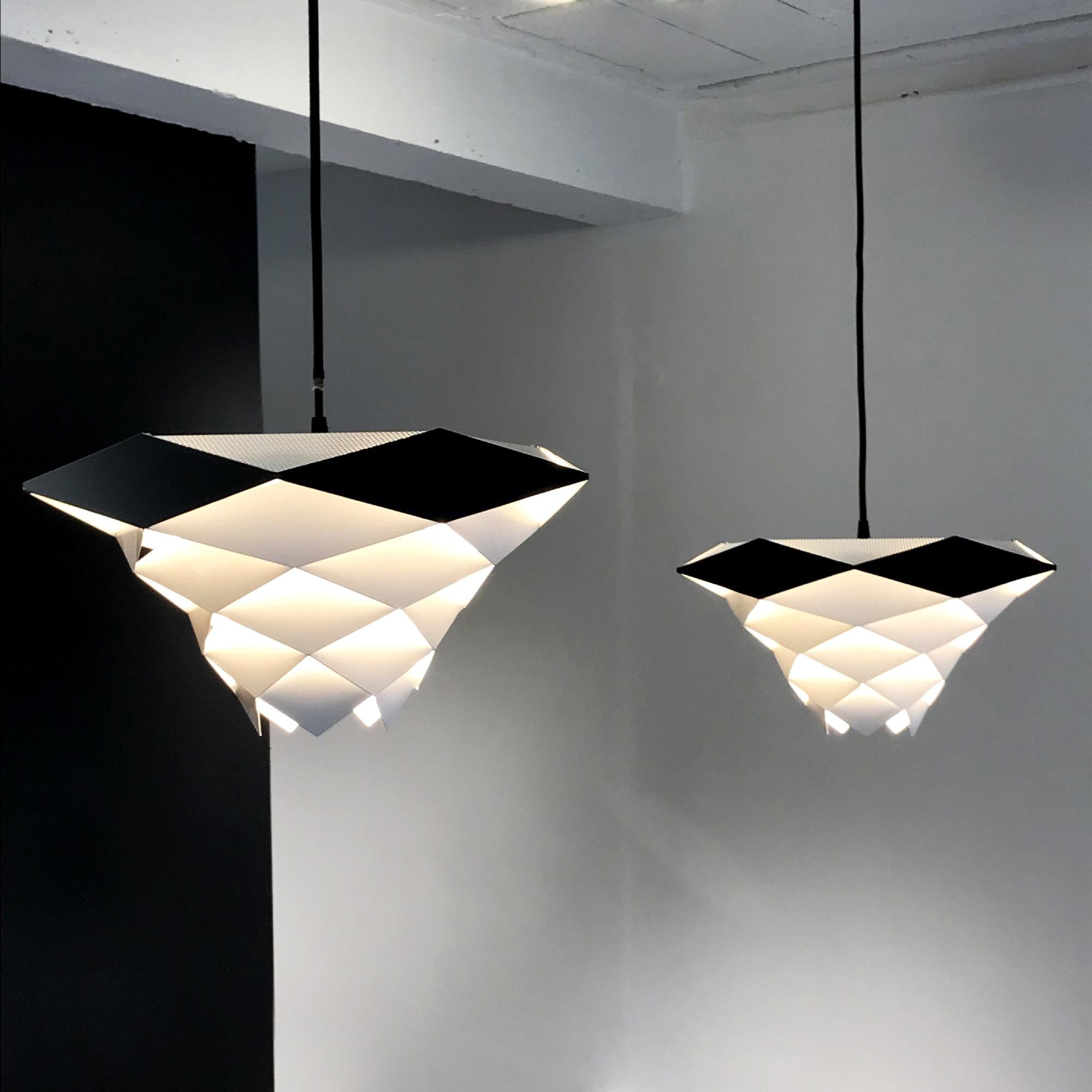 Pendant lamp model Symfoni by Preben Dal for H Følsgaard Elektro from Denmark circa 1960.
White and black painted lampshade made with metal parts diamonds shape assembled like an origami
No more in production.