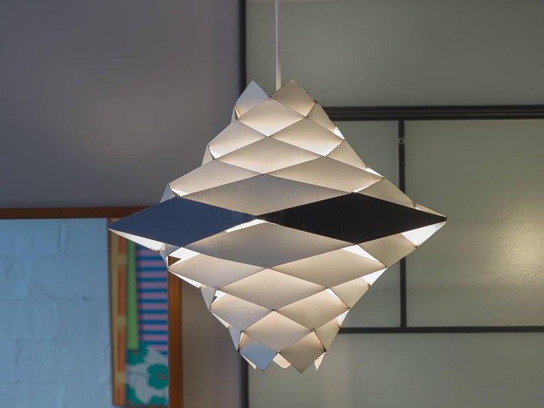 Obscure Symfoni pendant light designed by Preben Dahl for Hans Folsgaard. Spectacular geometric hanging pendant has rings of rhomboid facets that deflect and distribute the light within. Our 1960s example is in good vintage condition, with some